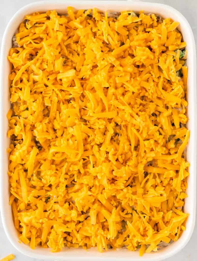 broccoli casserole topped with cheddar cheese
