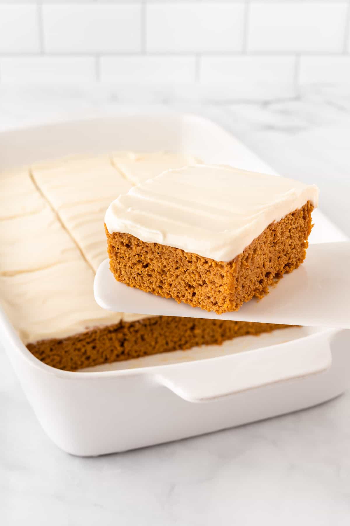 taking a pumpkin bar from the pan