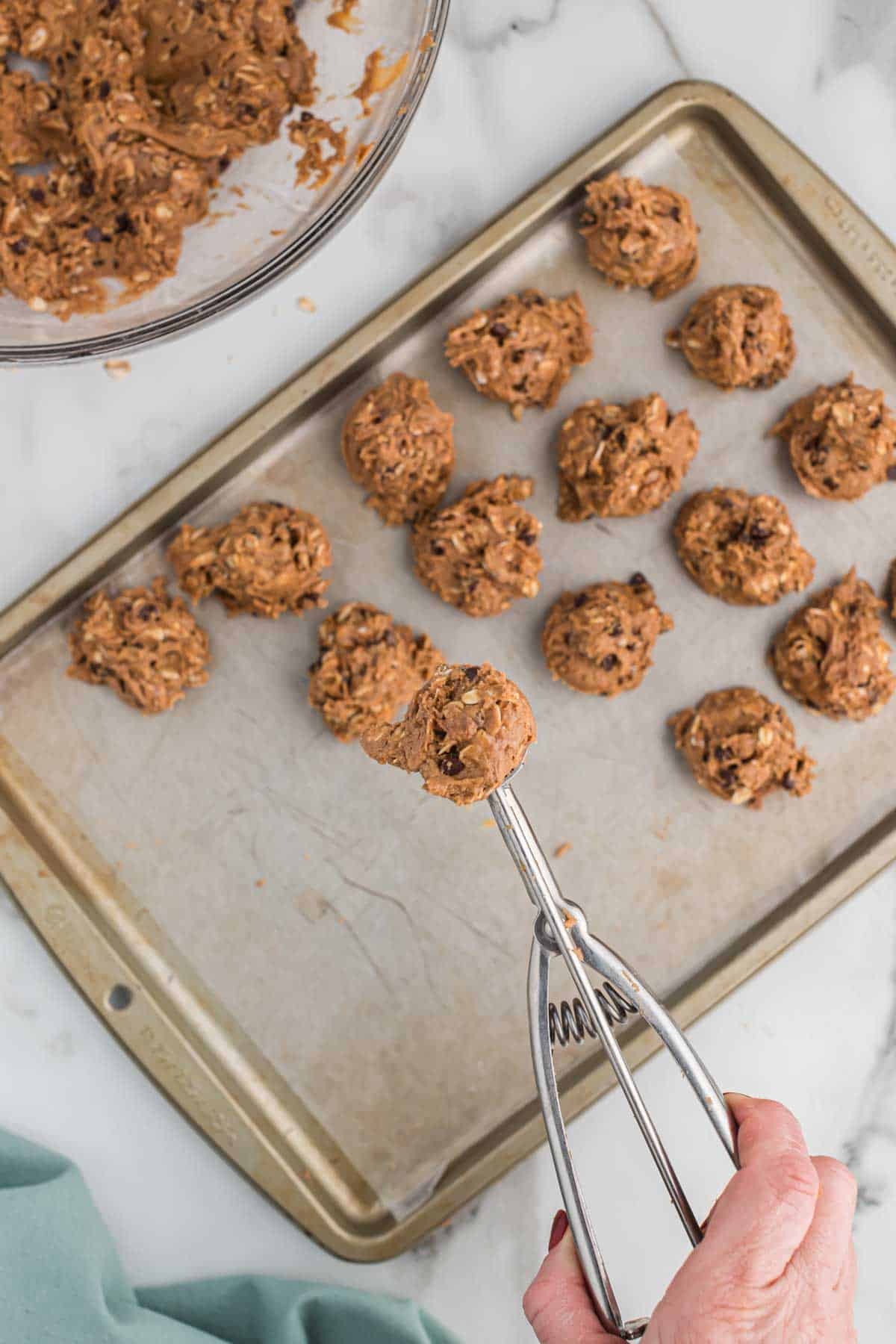 using a mini cookie scoop to form the protein balls