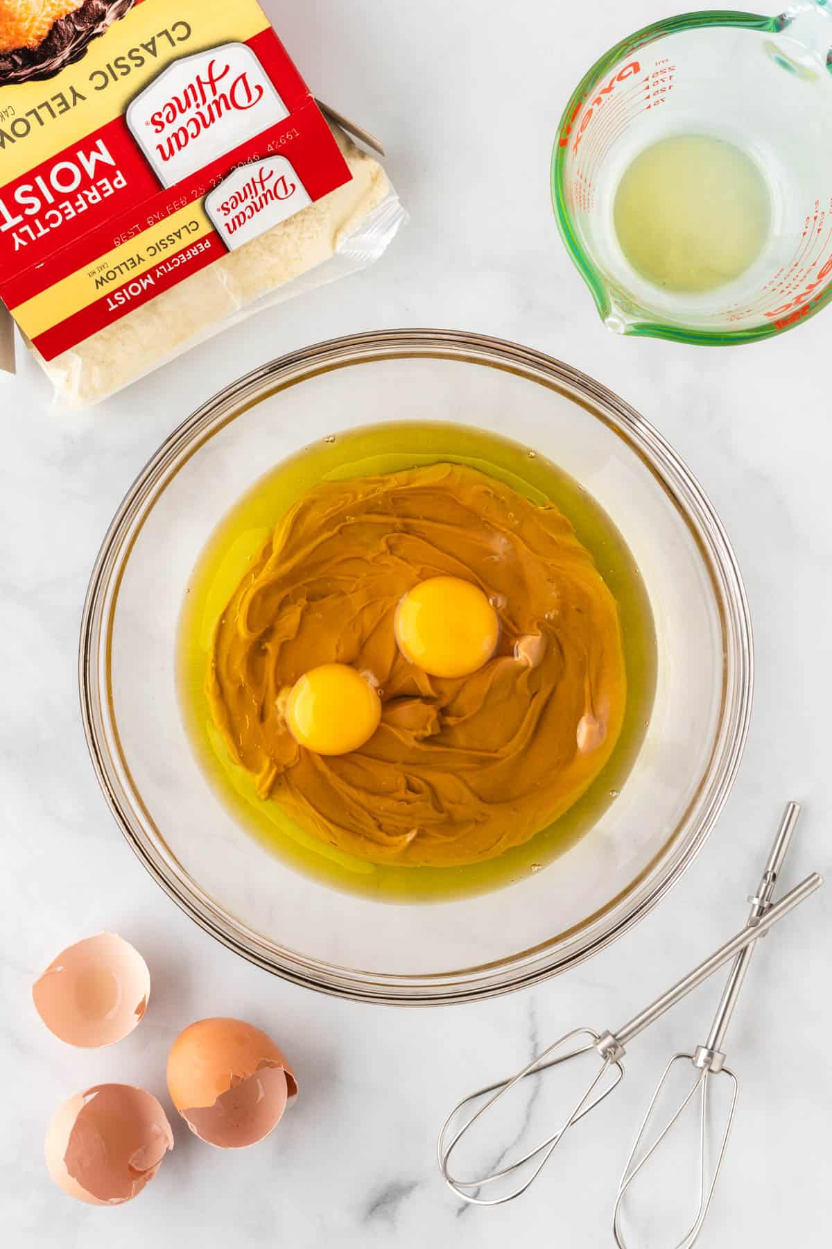 eggs, oil, and peanut butter in a mixing bowl