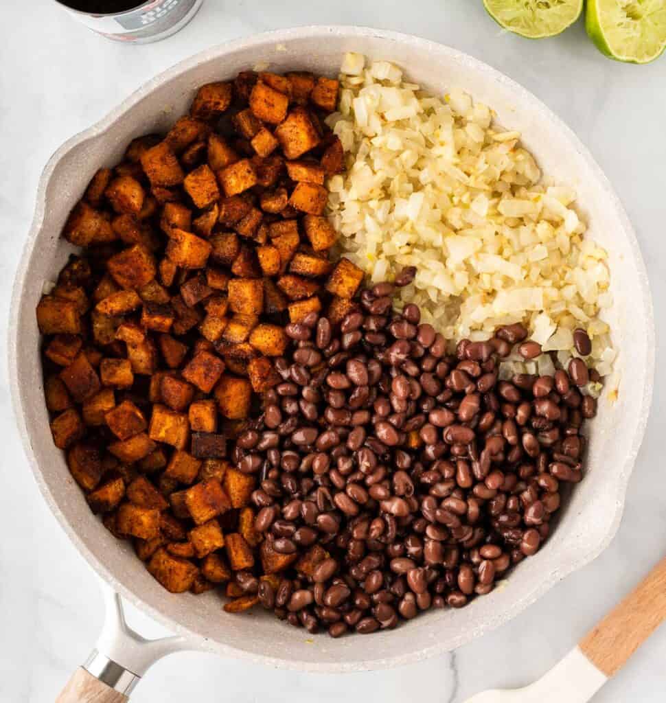 sweet potatoes, black beans, and garlic and onion in a skillet