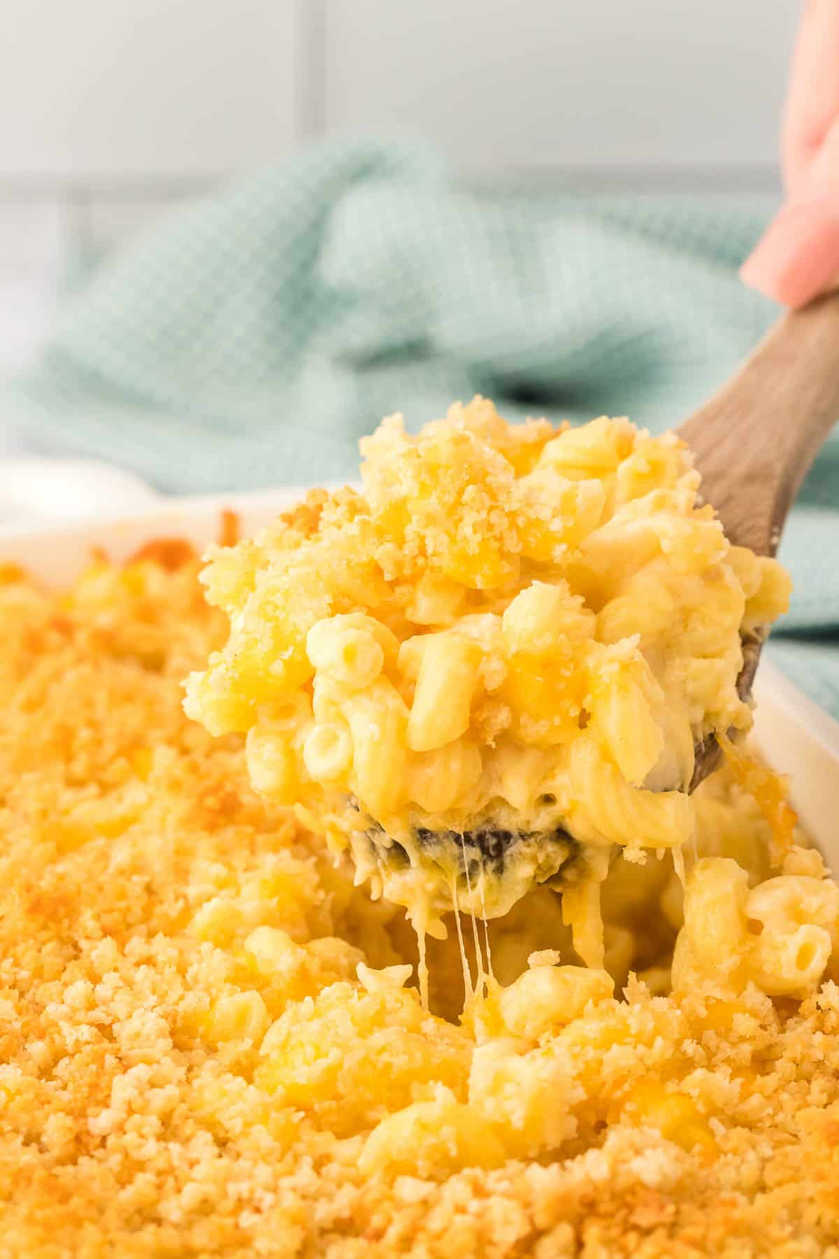 scooping mac and cheese from the baking dish