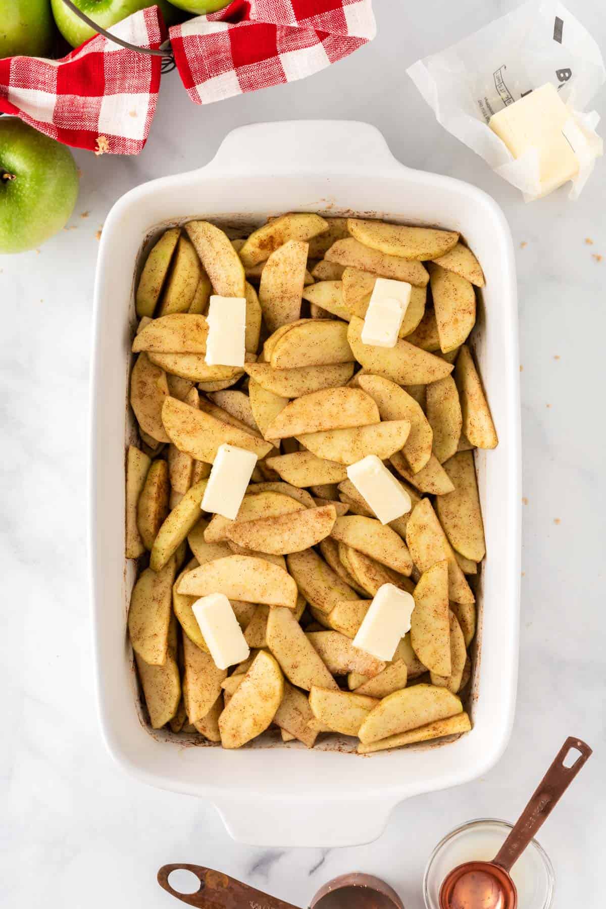 placing butter over the apples