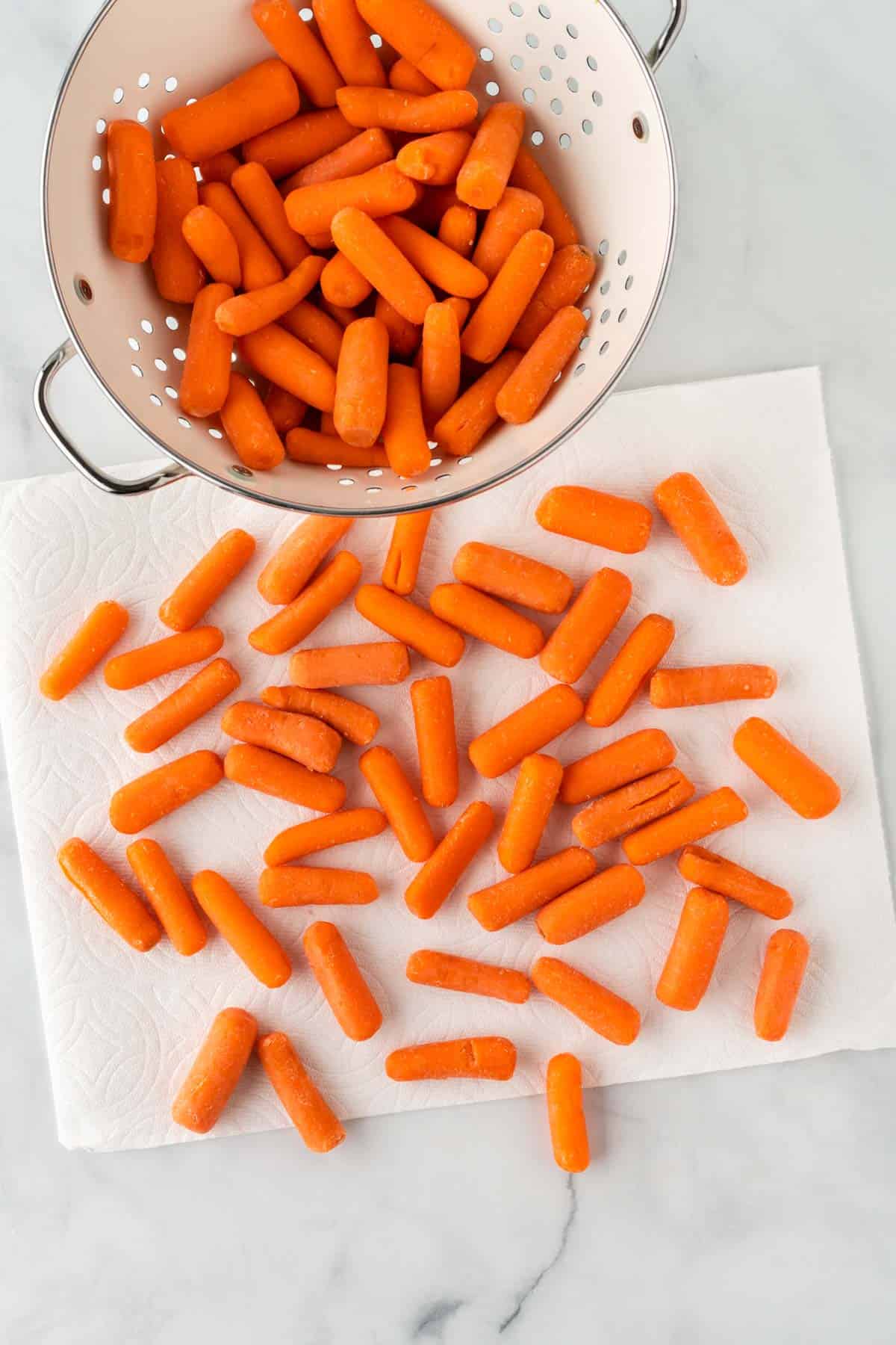 drying baby carrots on a paper towel
