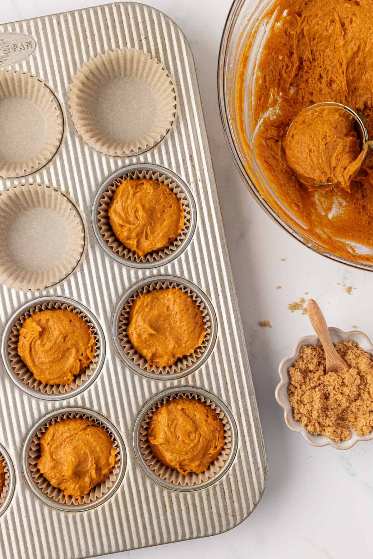 pumpkin batter in a muffin tin