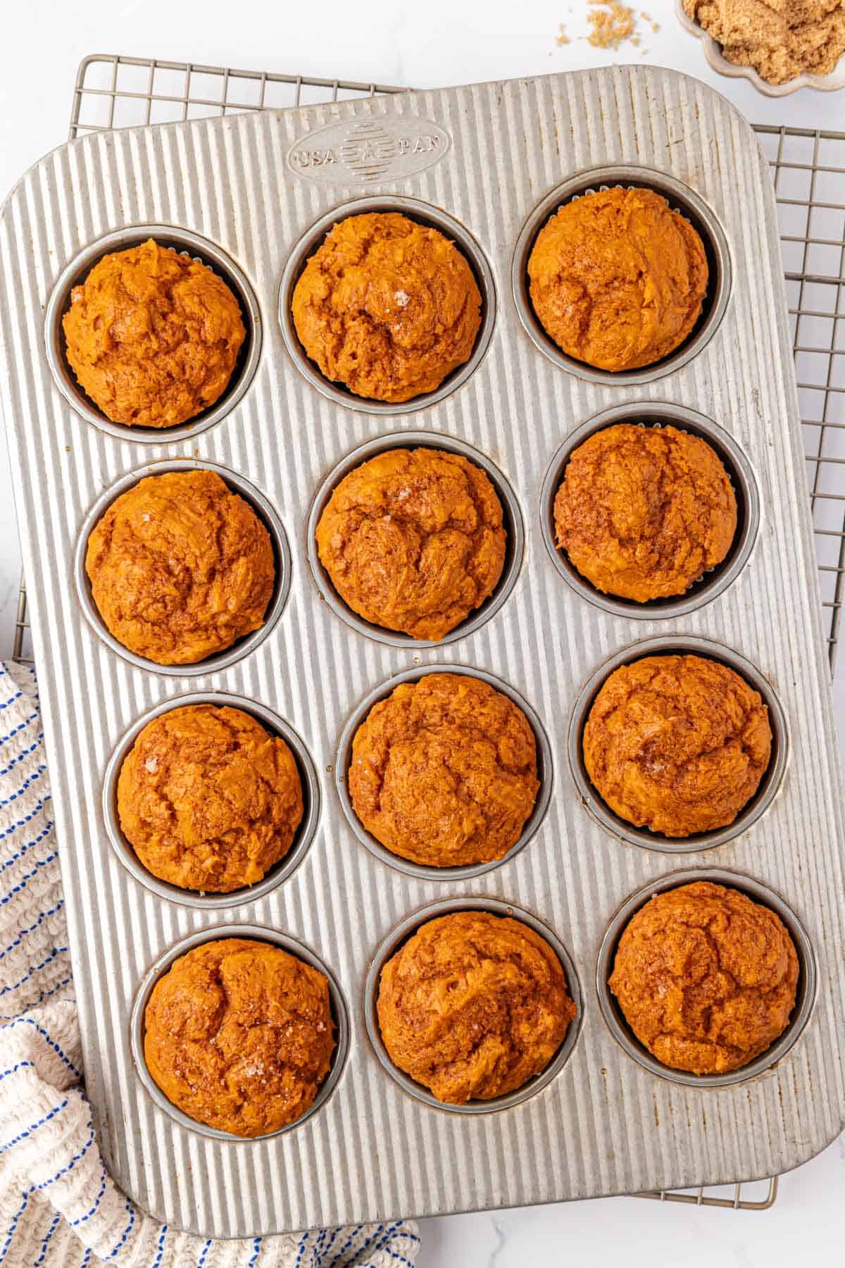 cake mix pumpkin muffins in a muffin tin