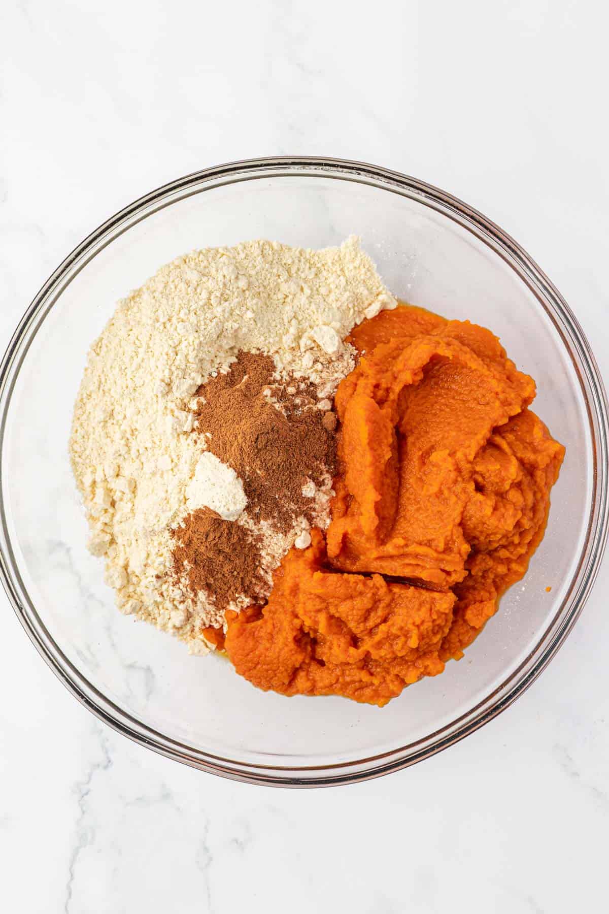 cake mix pumpkin muffin batter ingredients in a mixing bowl
