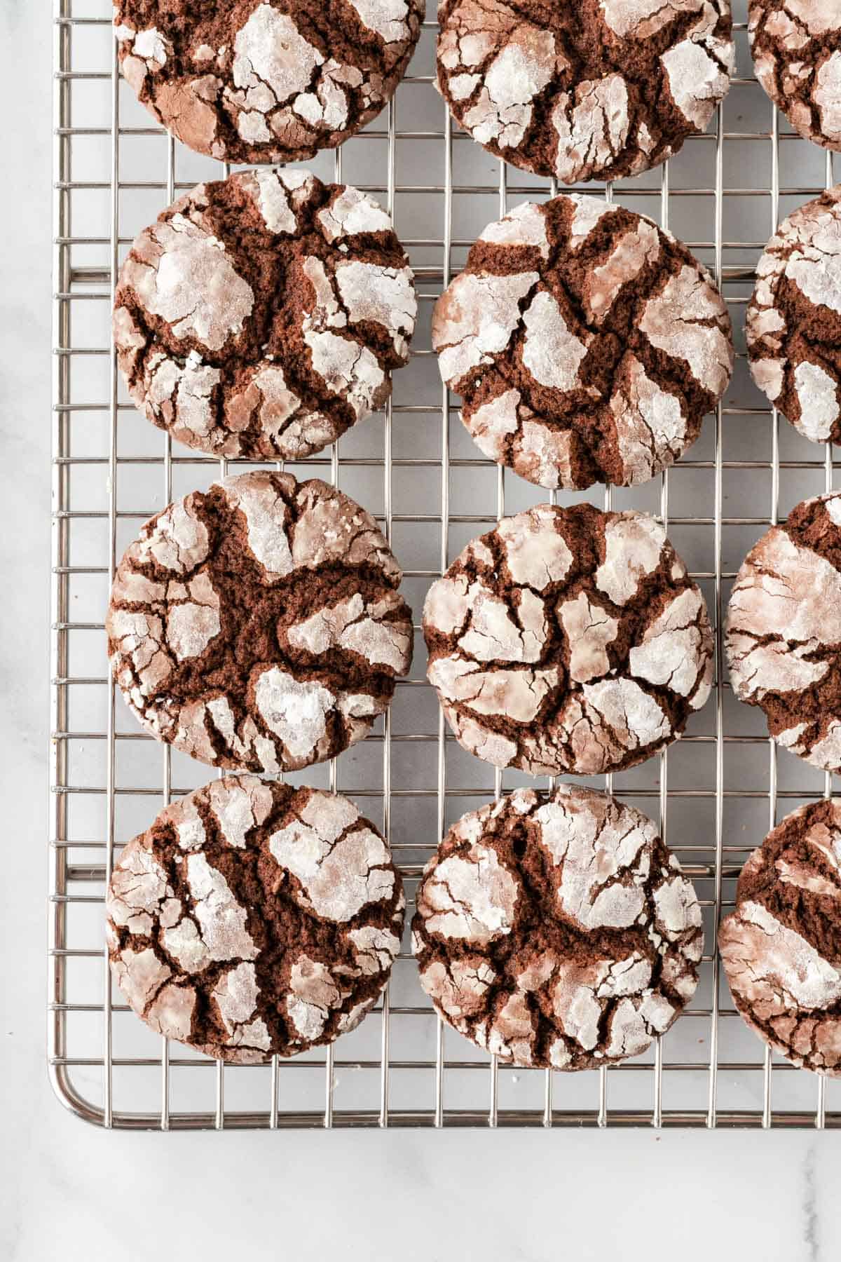 chocolate crinkle cookies on a wire cooling rack
