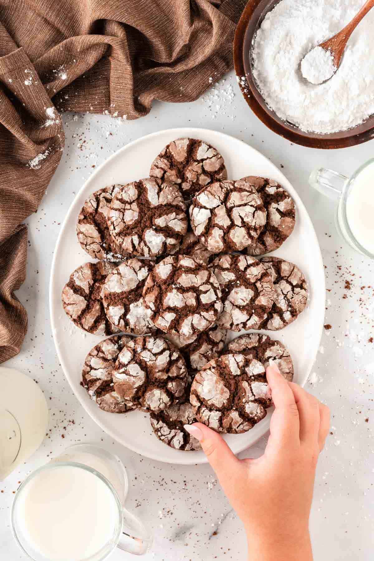 taking a crinkle cookie from a platter