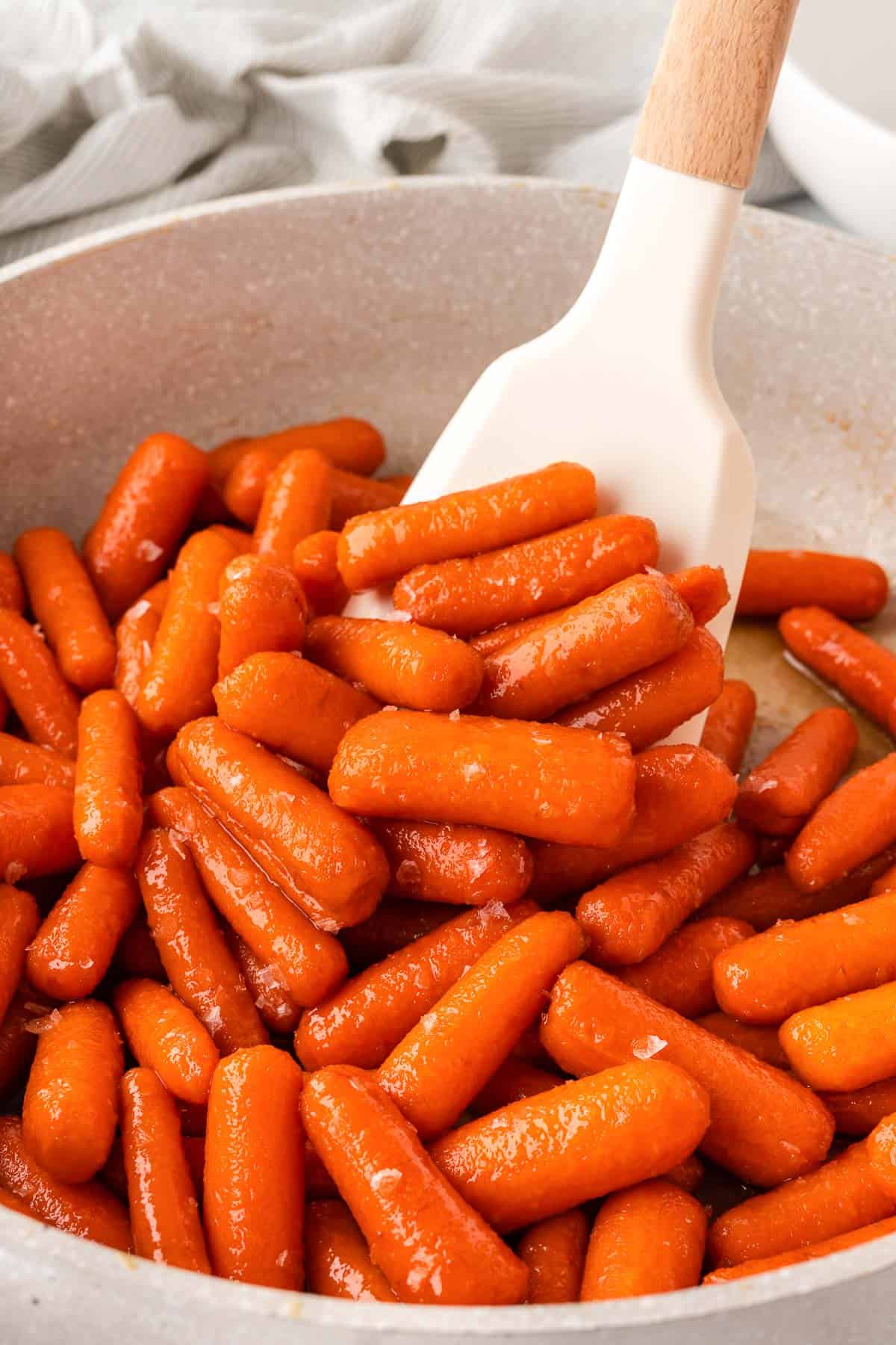 stirring the glazed carrots