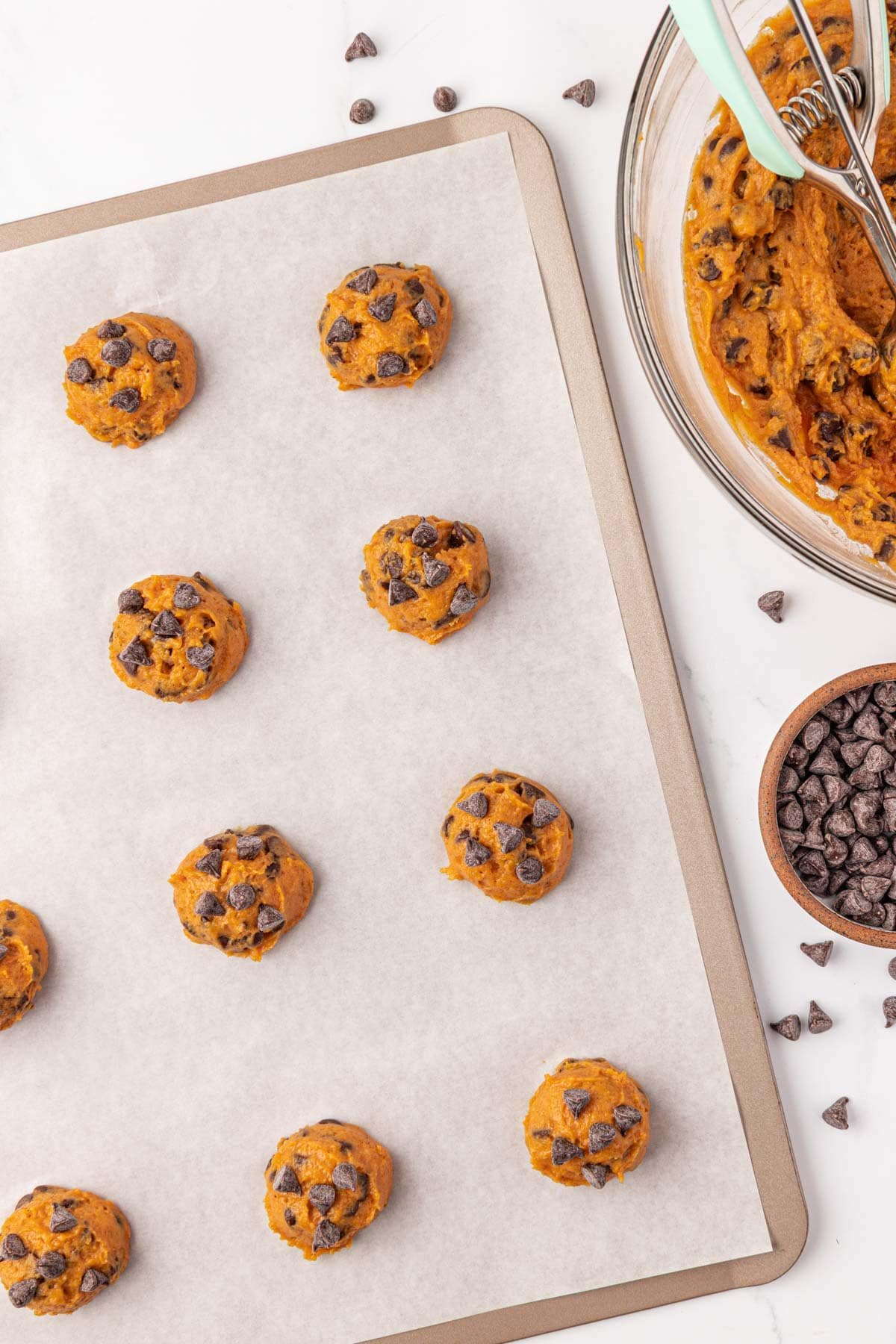 pumpkin chocolate chip cookie batter on a baking sheet