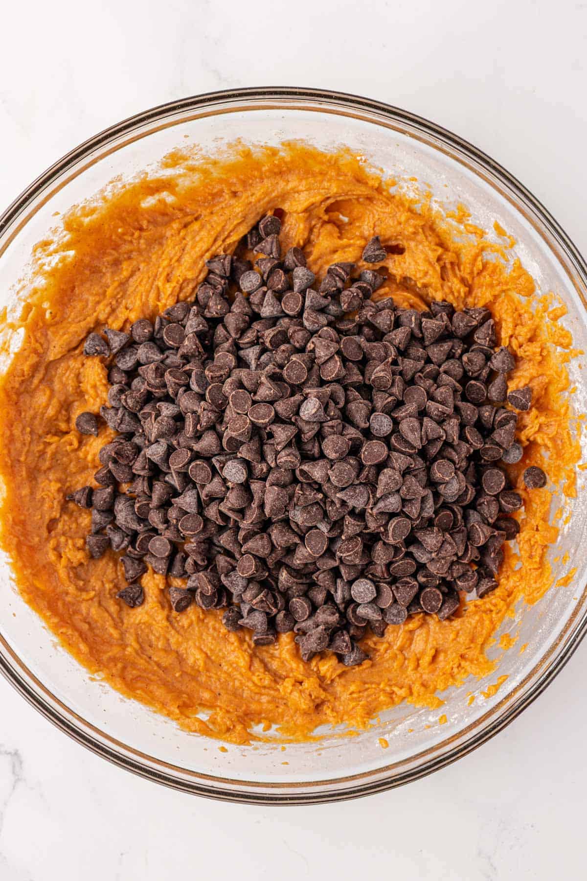 adding the chocolate chips to the cookie batter