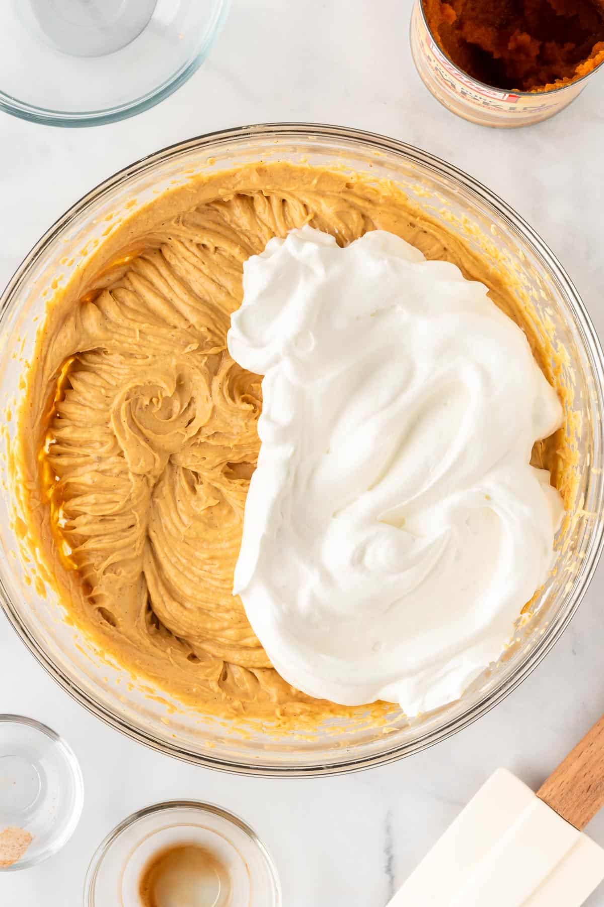 adding the whipped cream to the pumpkin cheesecake mixture