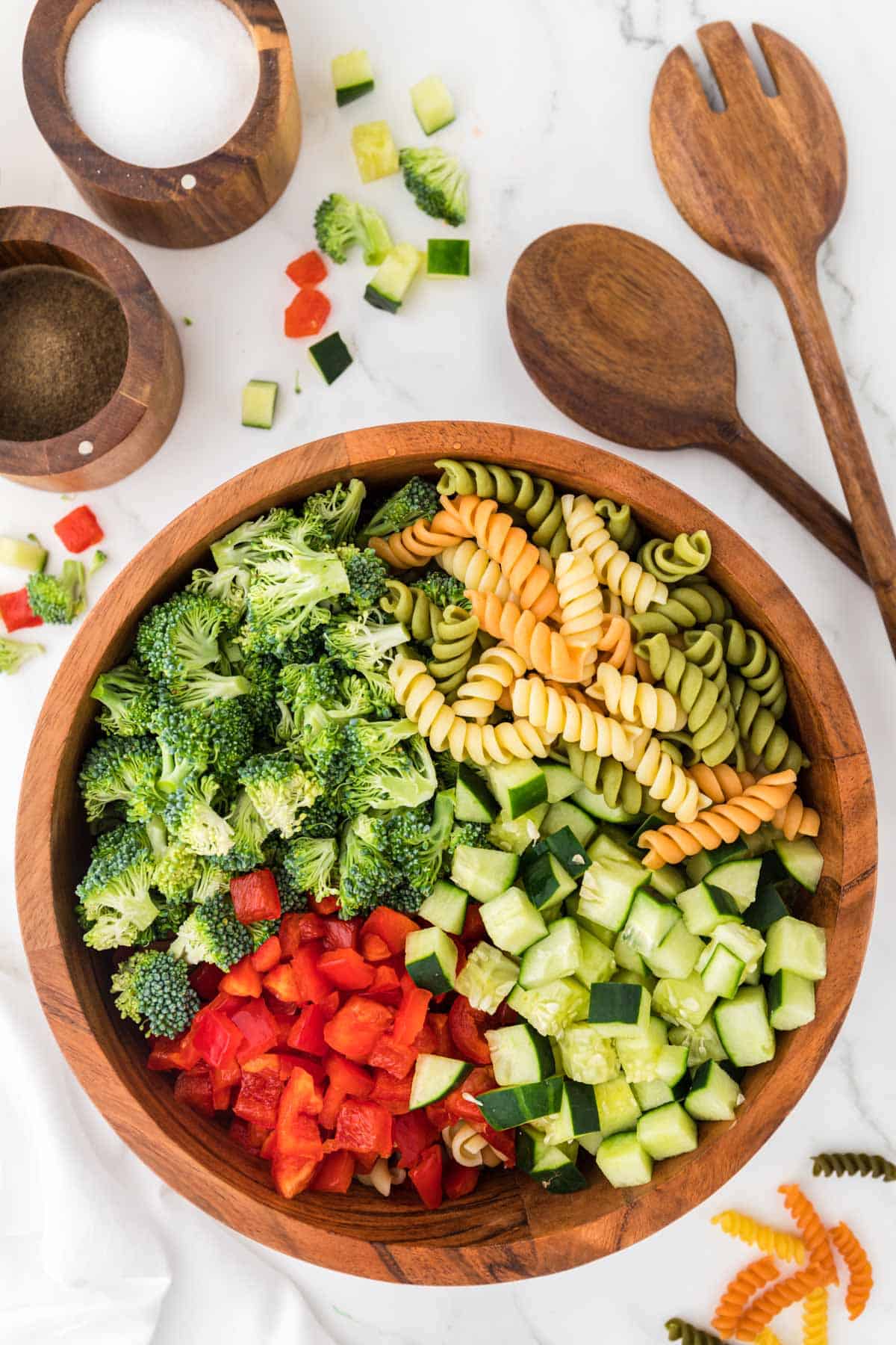 broccoli, bell pepper, and cucumber on top of the rotini