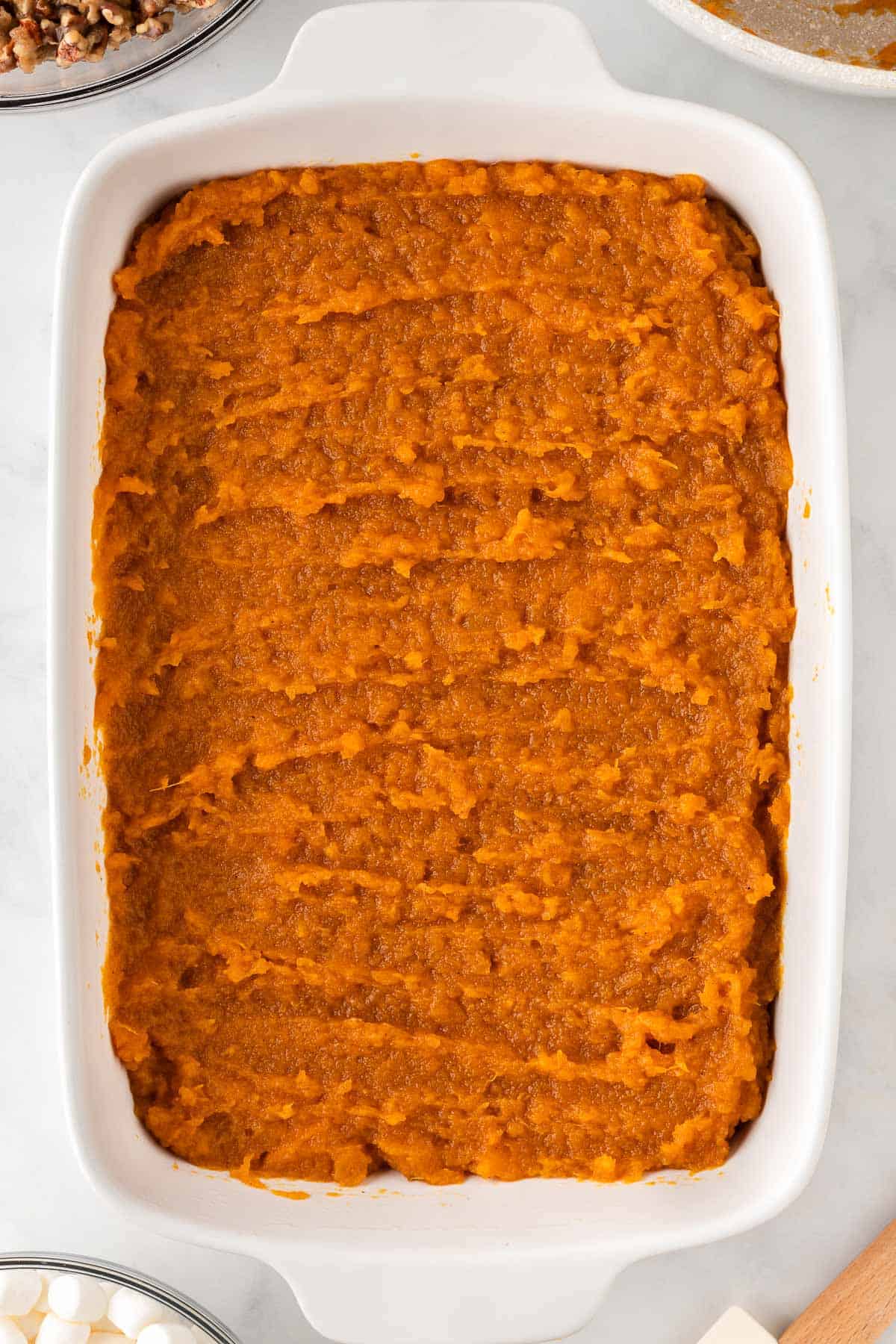sweet potato filling spread out in a 9 by 13 baking dish