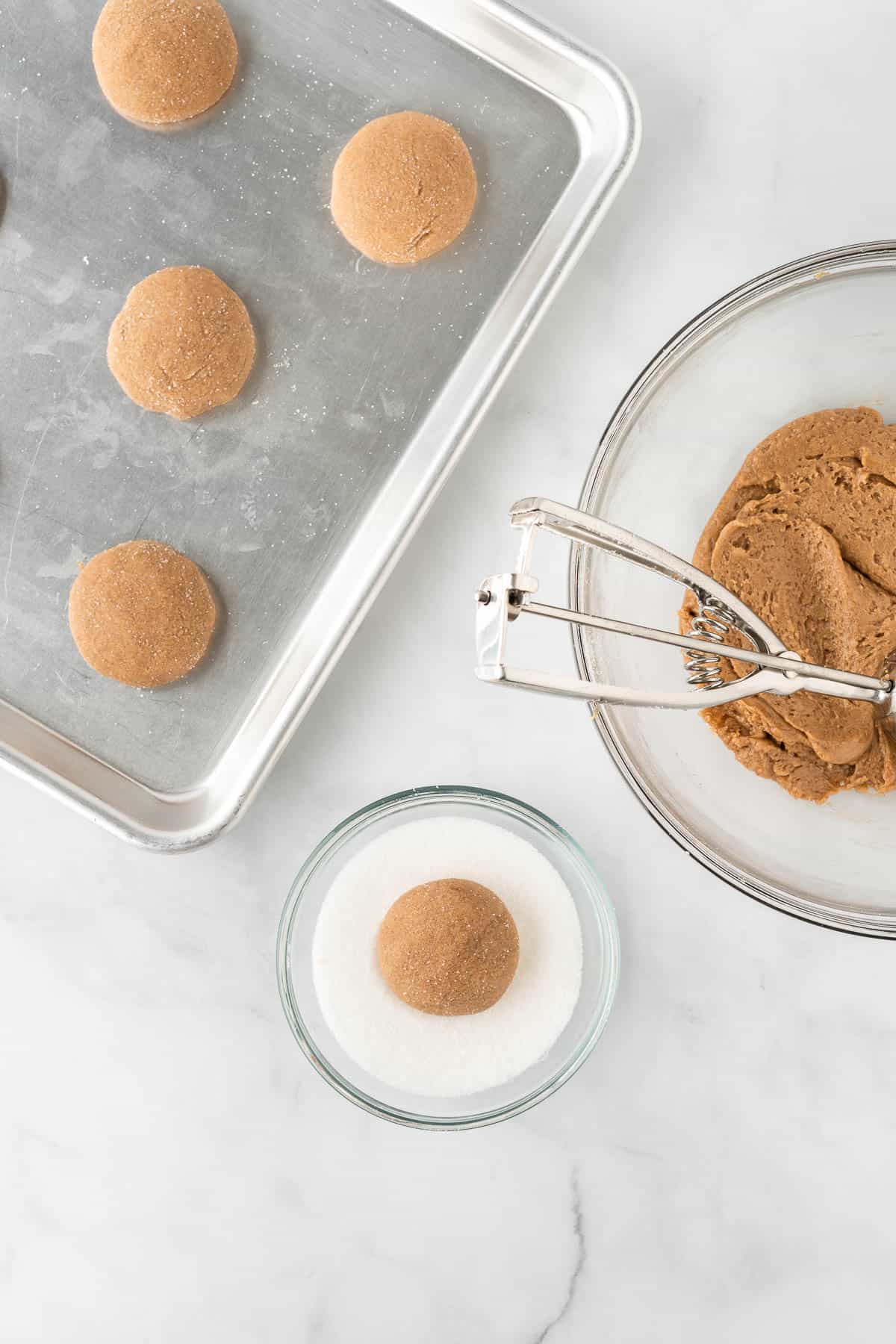 rolling the dough balls in sugar