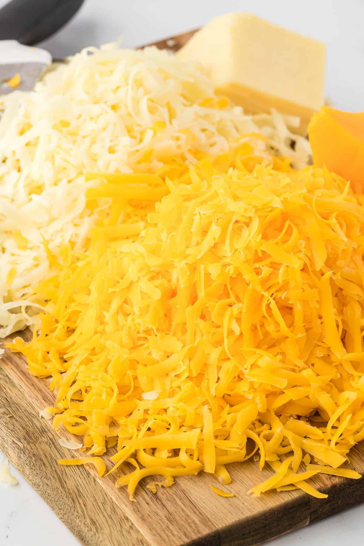 freshly grated cheese on a cutting board