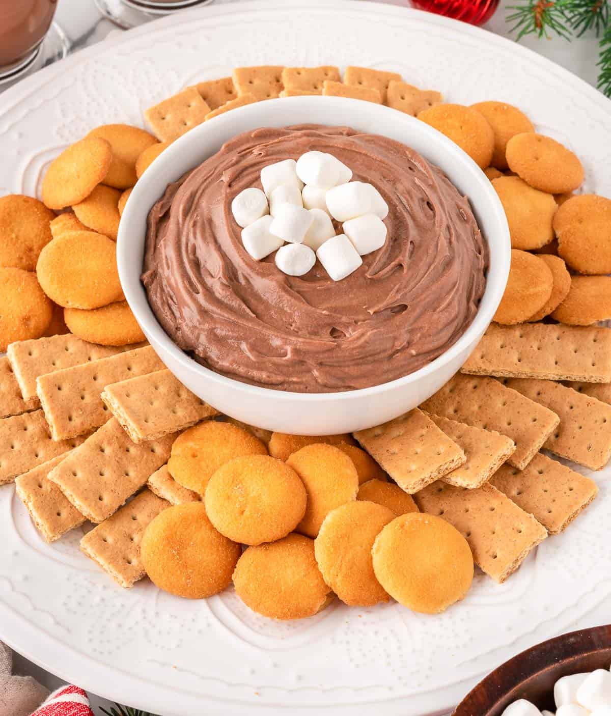 hot chocolate dip on a platter with Nilla wafers and graham crackers