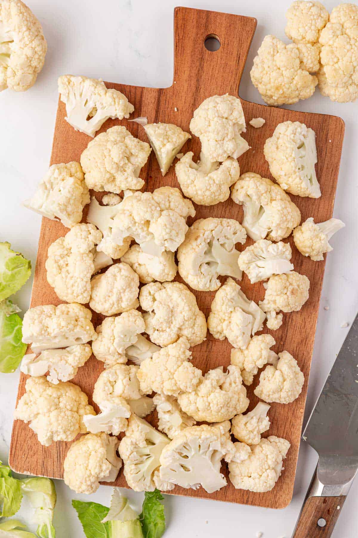 cauliflower florets on a cutting board