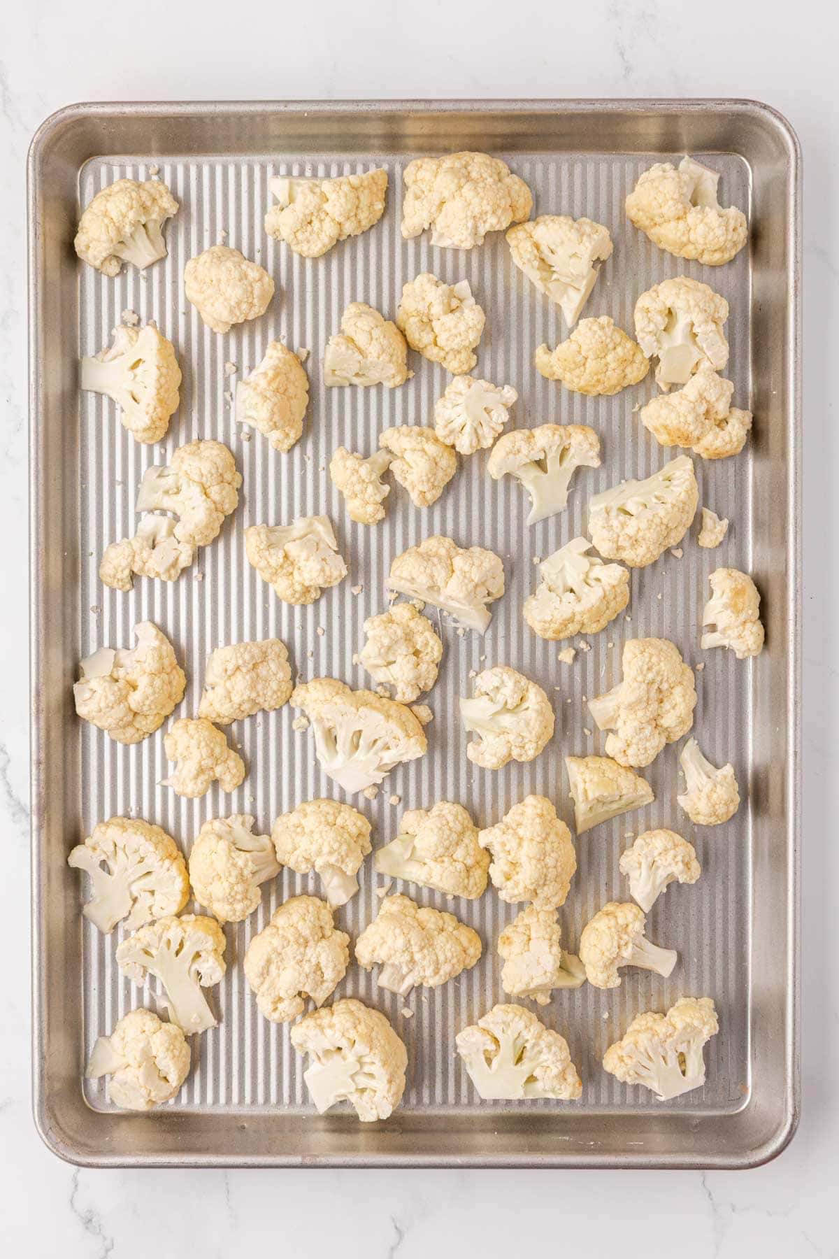 cauliflower florets on a baking sheet