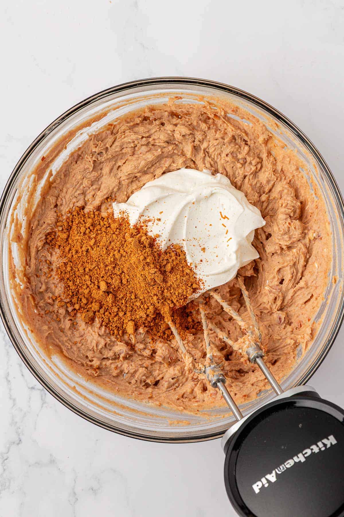 adding the sour cream and taco seasoning to the bean mixture
