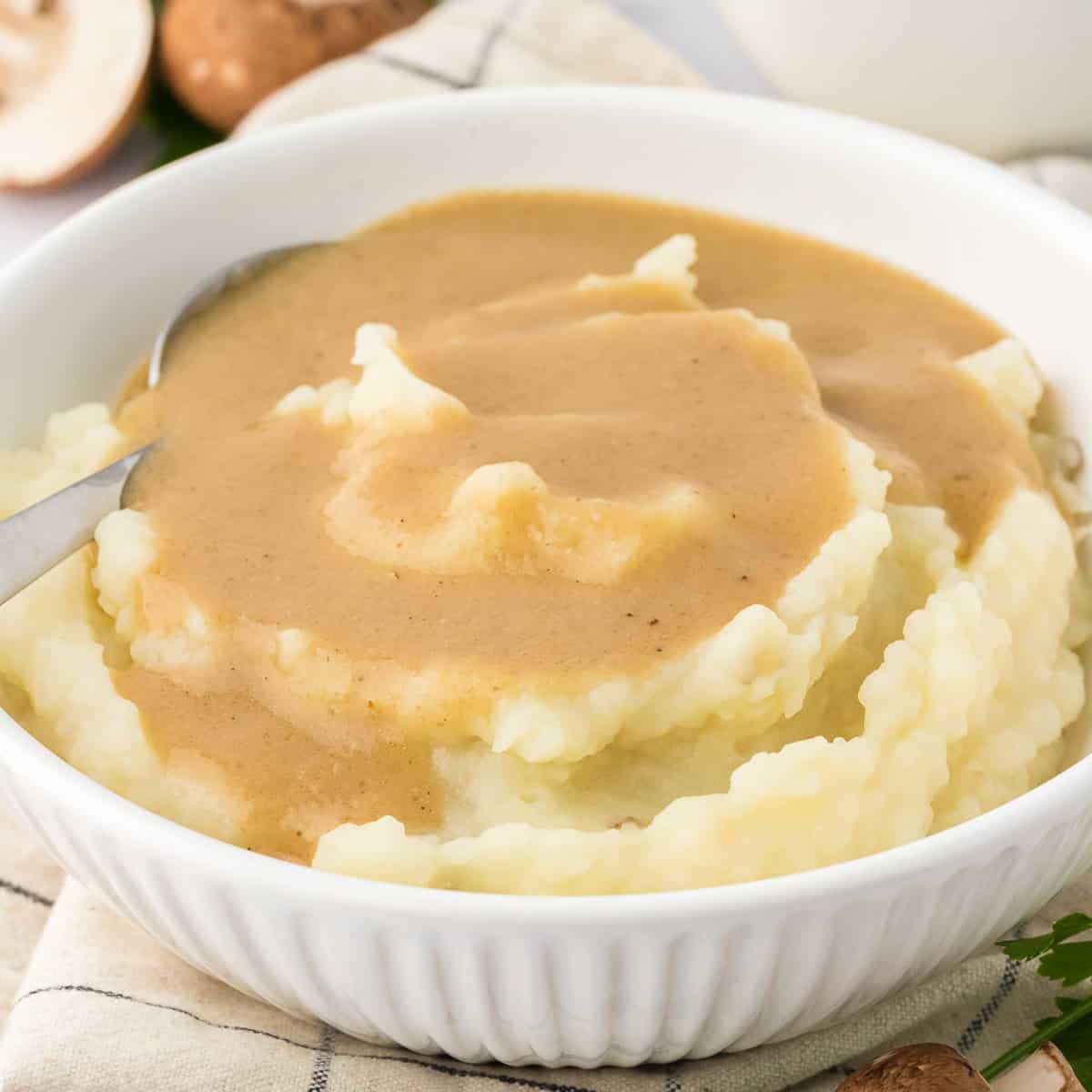 bowl of mashed potatoes topped with vegetarian gravy