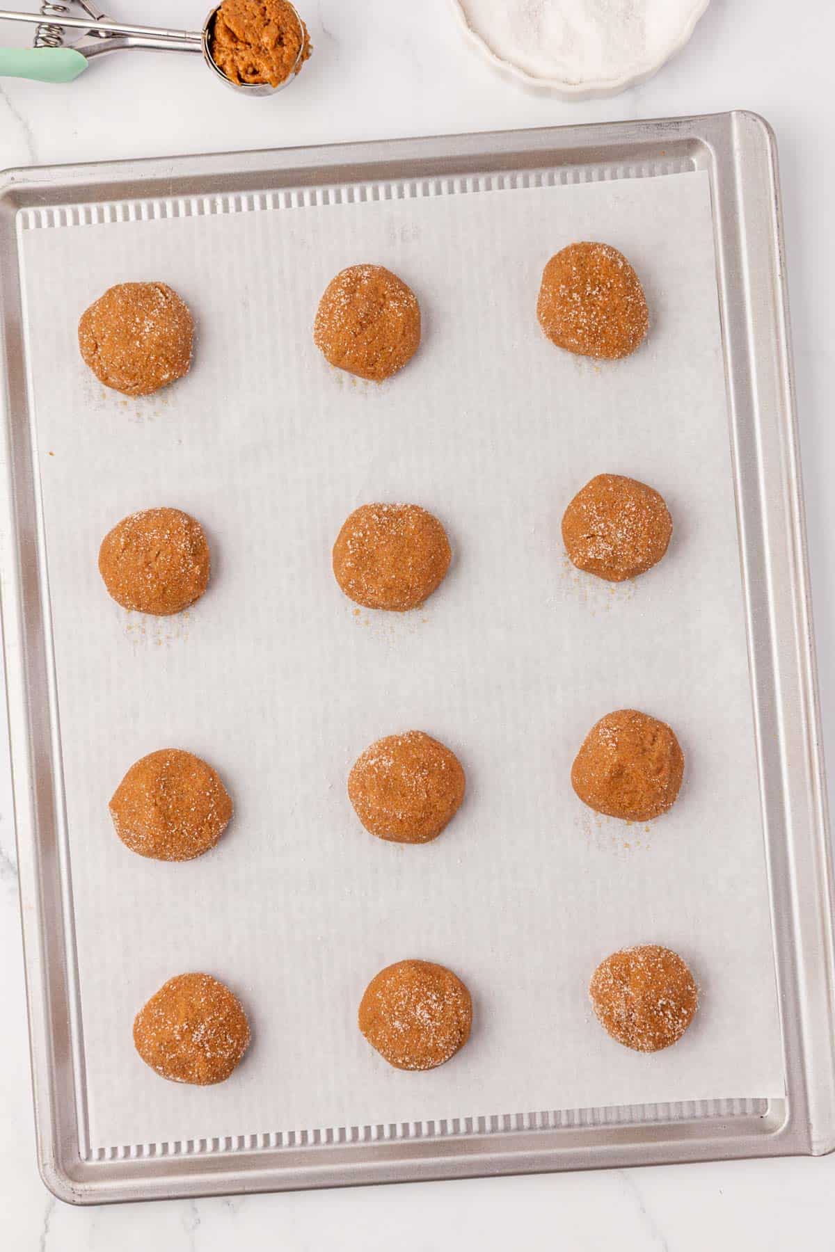 balls of cookie dough on a baking sheet