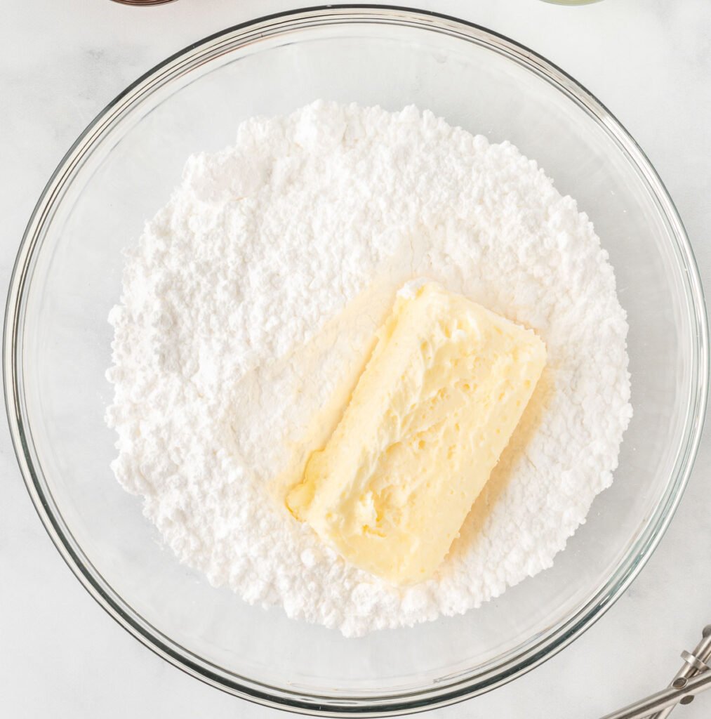 powdered sugar and softened butter in a mixing bowl