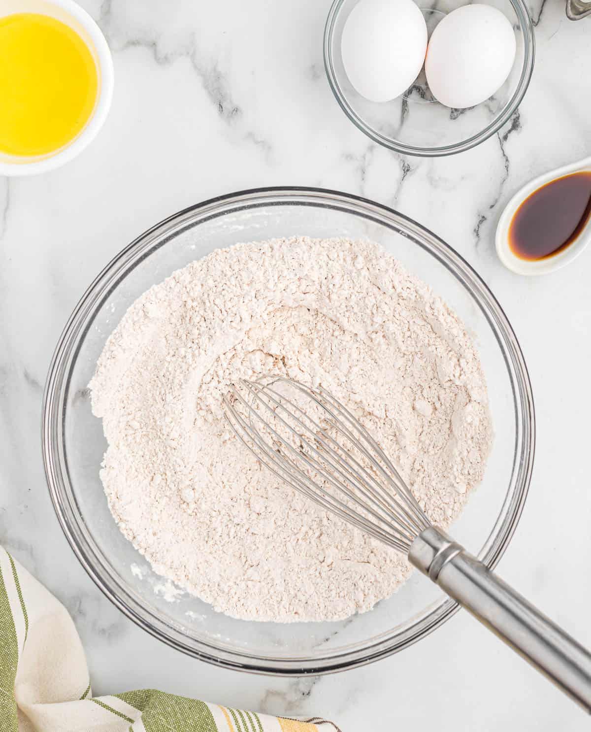 whisking the dry ingredients in a mixing bowl