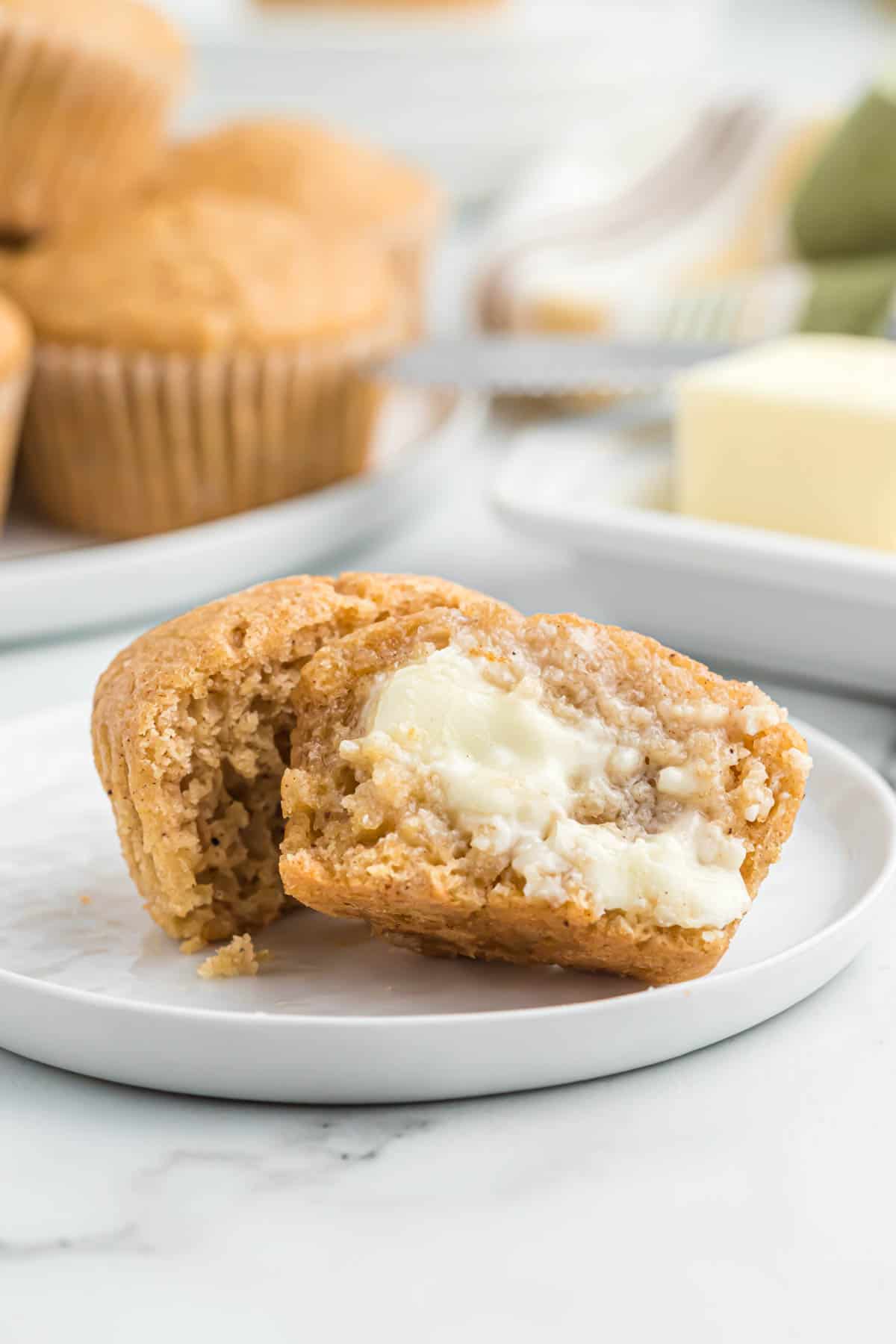 applesauce muffin cut open with butter smeared on it