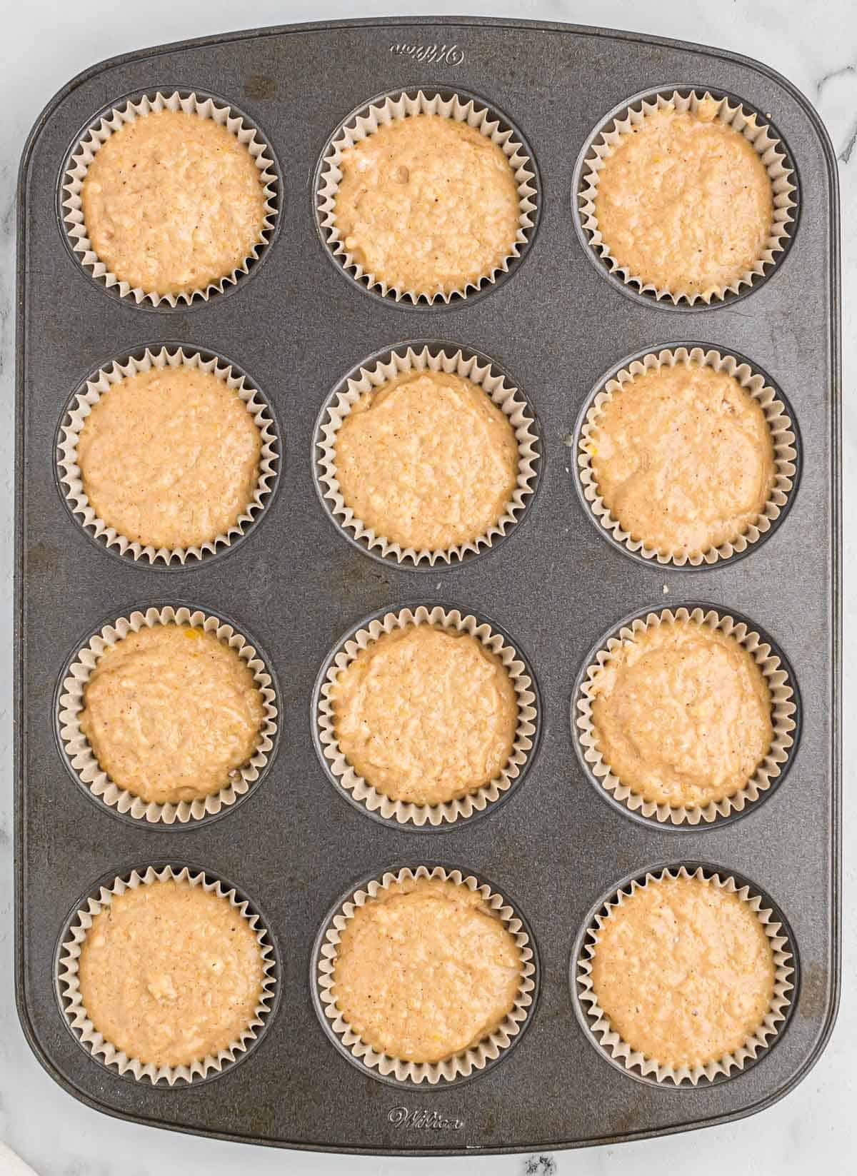 applesauce muffin batter in the muffin tin