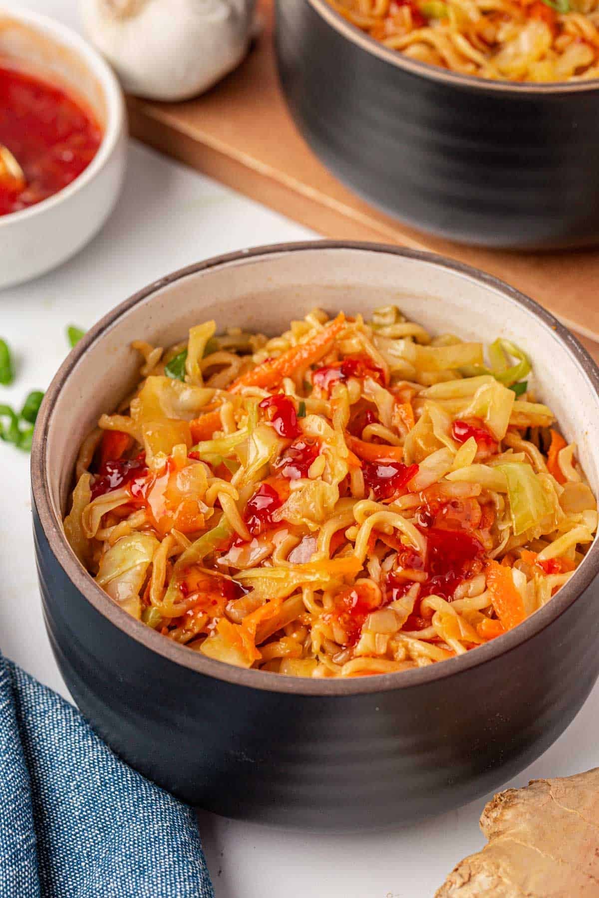 cabbage stir fry in a bowl with sweet chili sauce