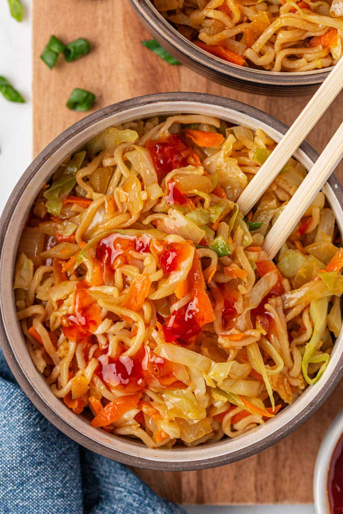 cabbage stir fry in a bowl with sweet chili sauce