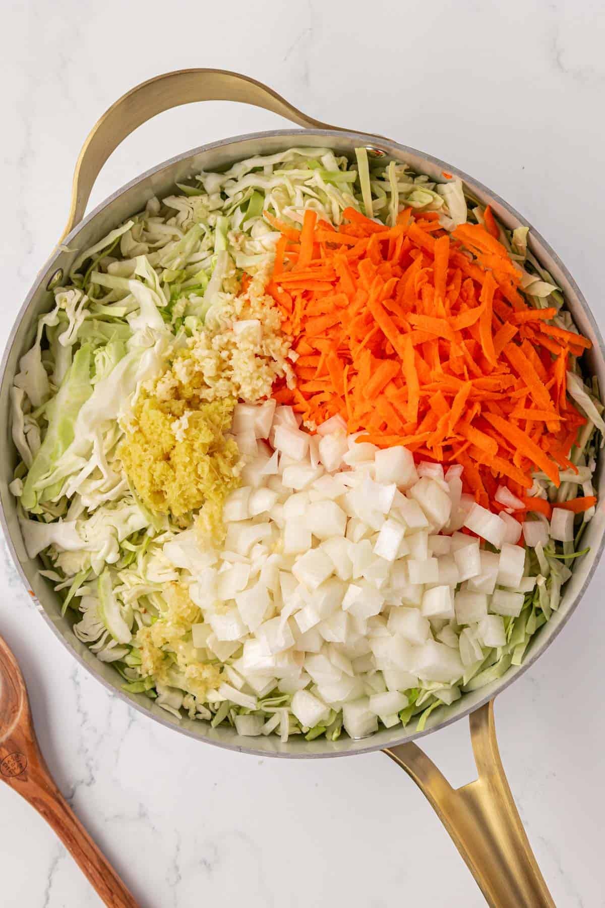 cabbage, garlic, ginger, onion, and carrots in a skillet