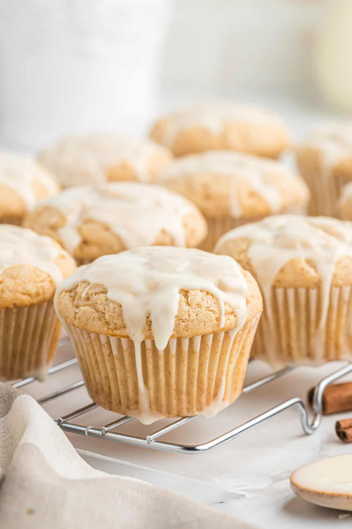 glazed eggnog muffins on a wire cooling rack