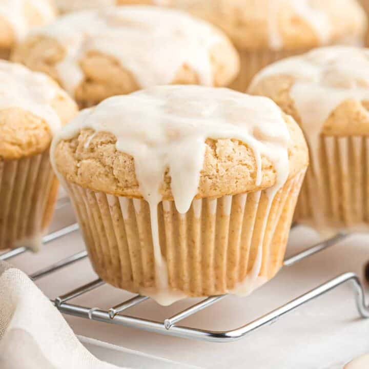 glazed eggnog muffins on a wire cooling rack