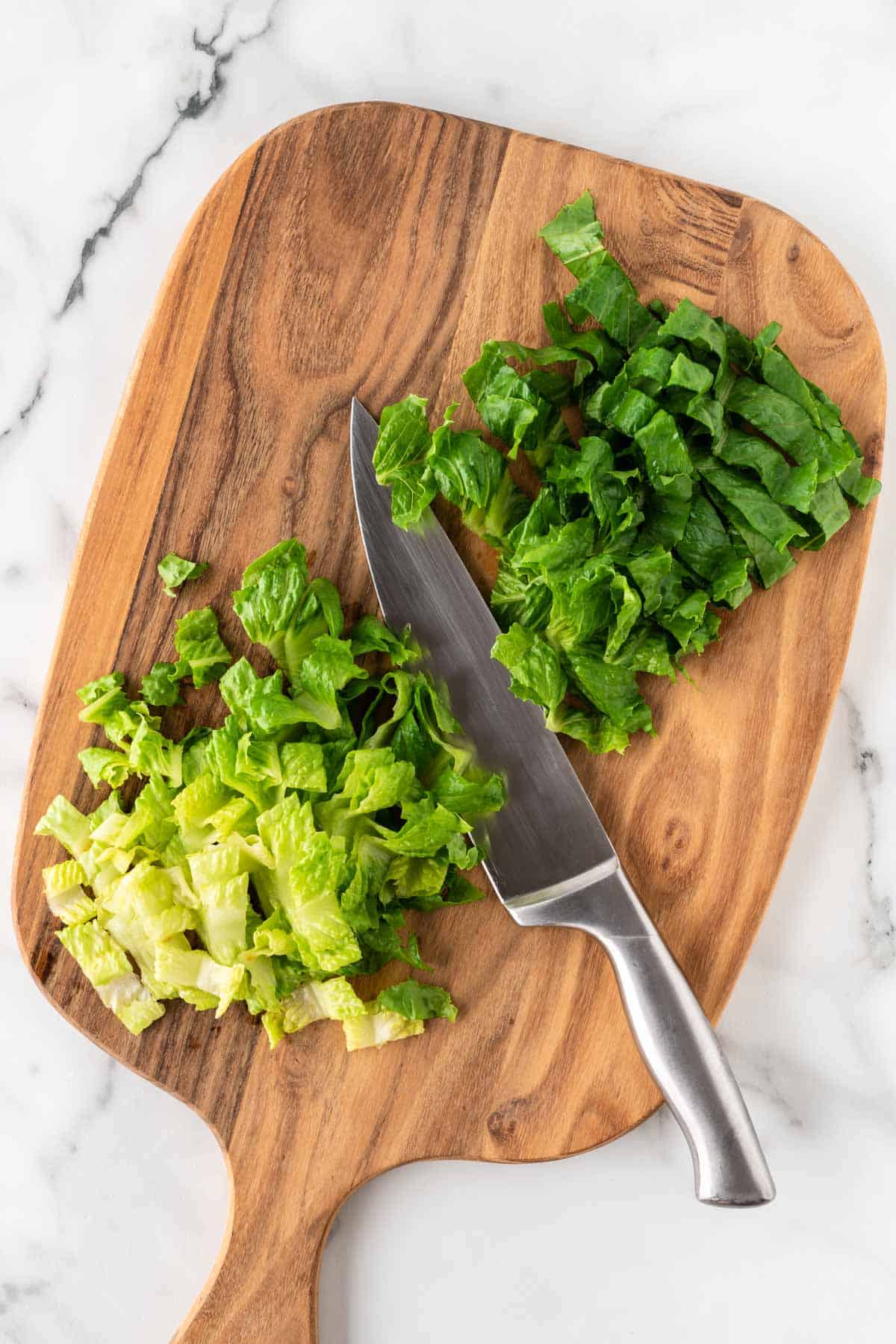 cut up romaine lettuce on a cutting board