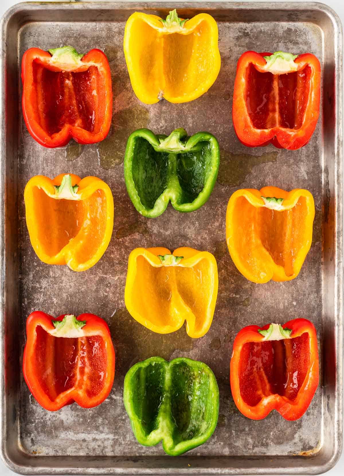 bell peppers cut open on a baking sheet