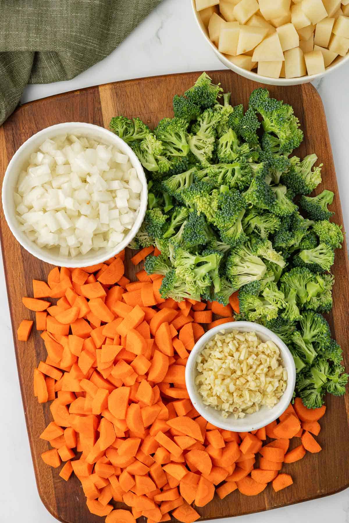 chopped up vegetables for soup on a cutting board