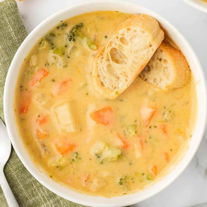 vegetable soup in a bowl with baguette slices