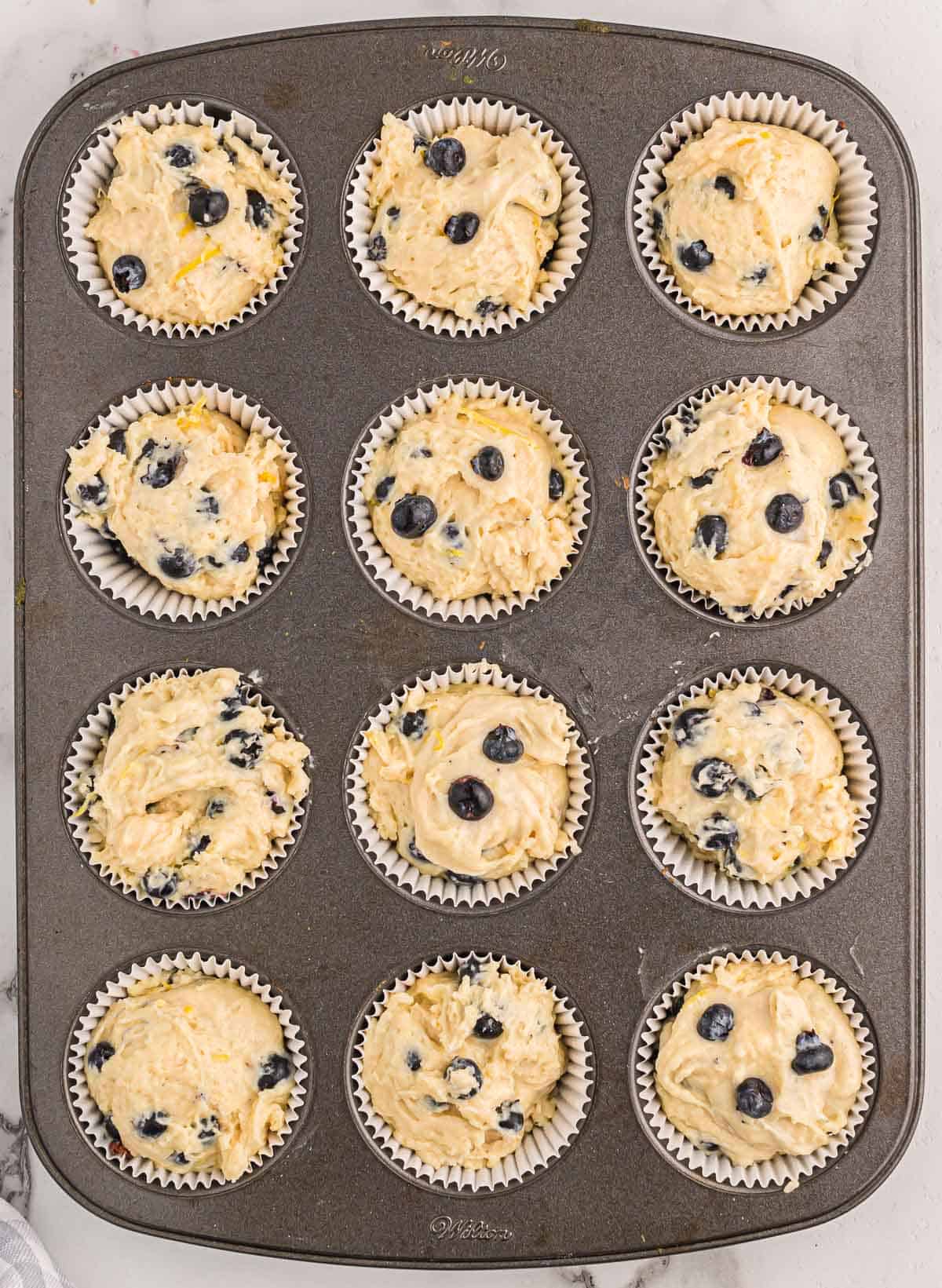 muffin tin filled with batter
