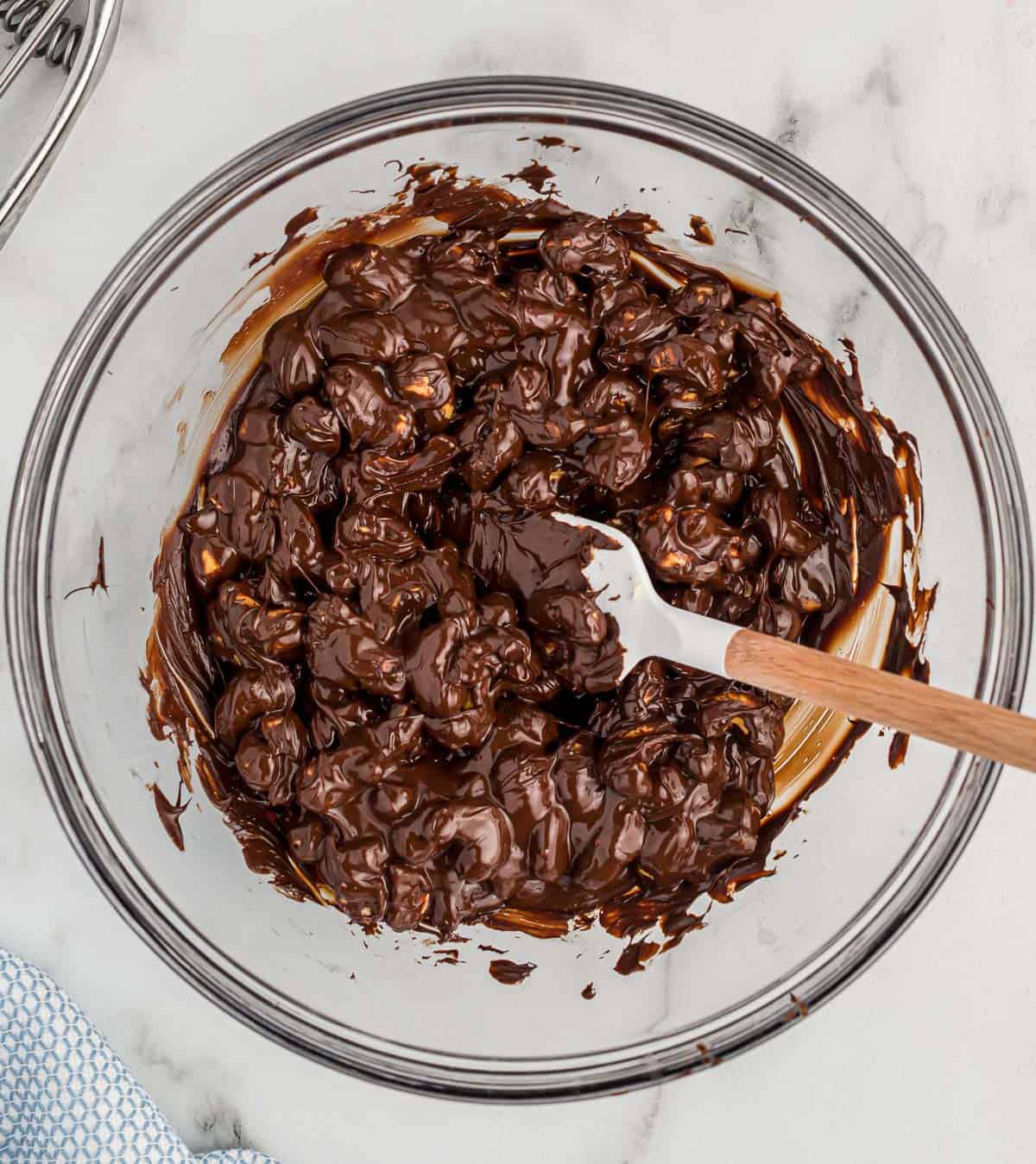 mixing the cashews into the melted chocolate