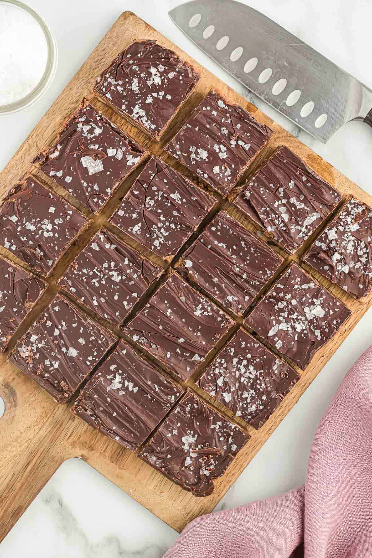 chocolate protein bars cut into slices on a cutting board