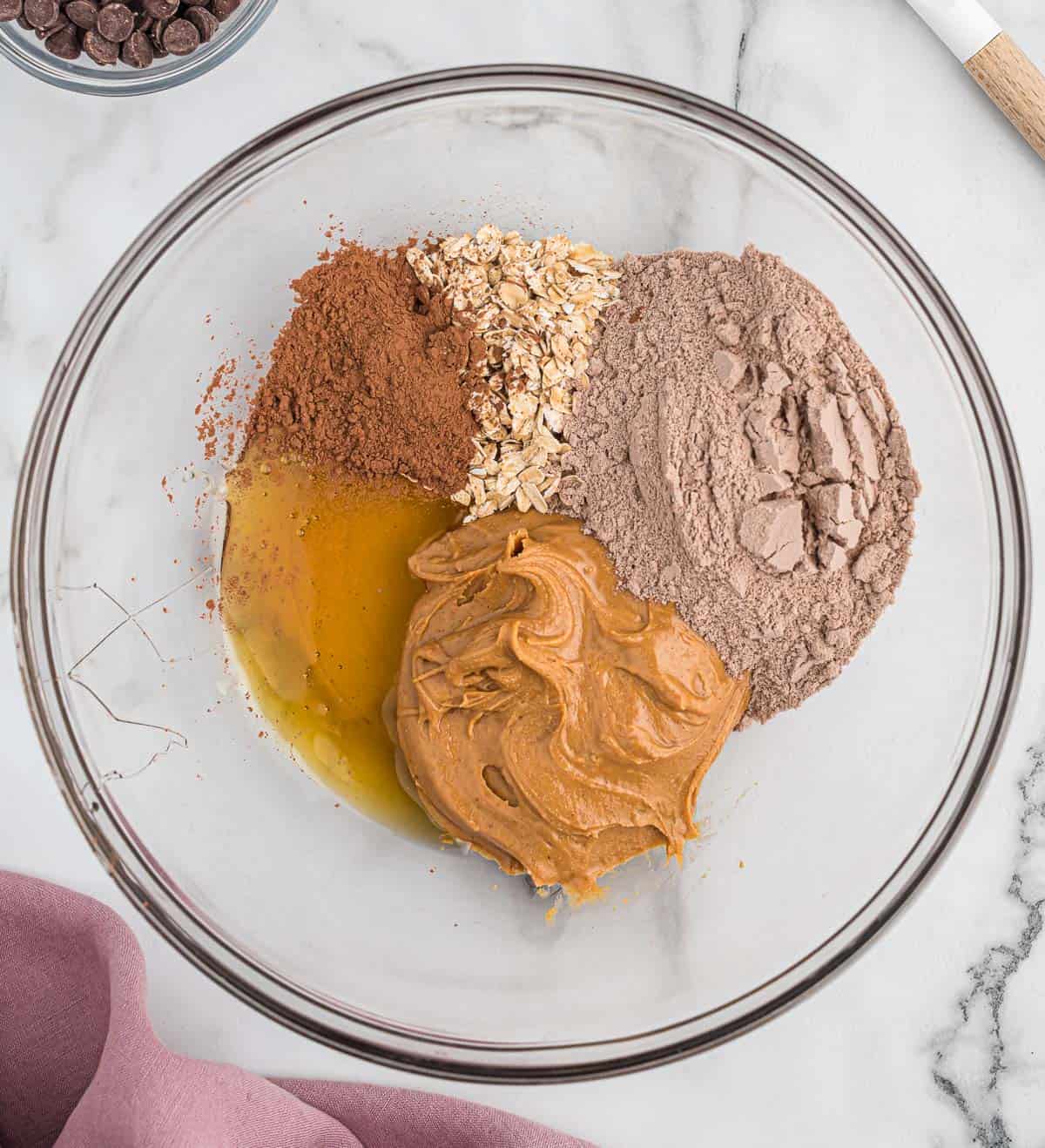 adding the protein bar ingredients to a mixing bowl