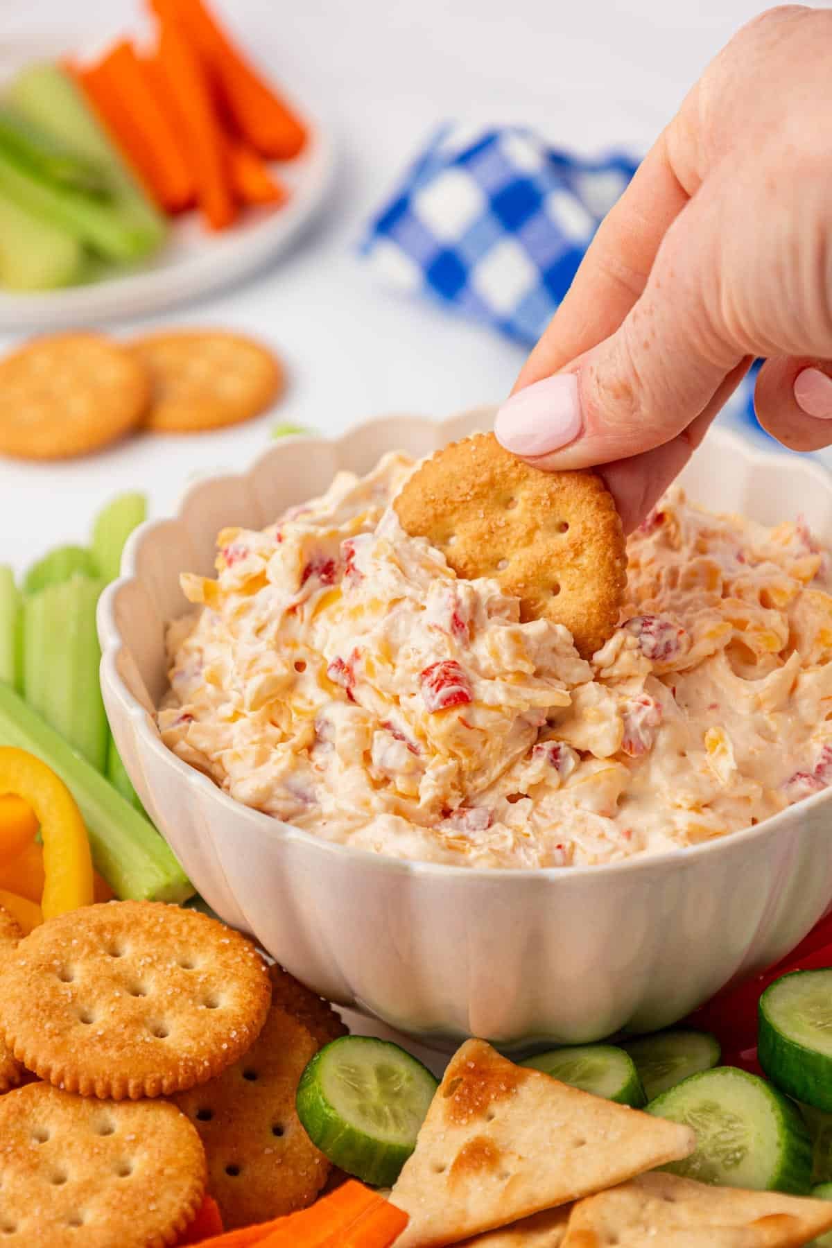 dipping a cracker into pimento cheese