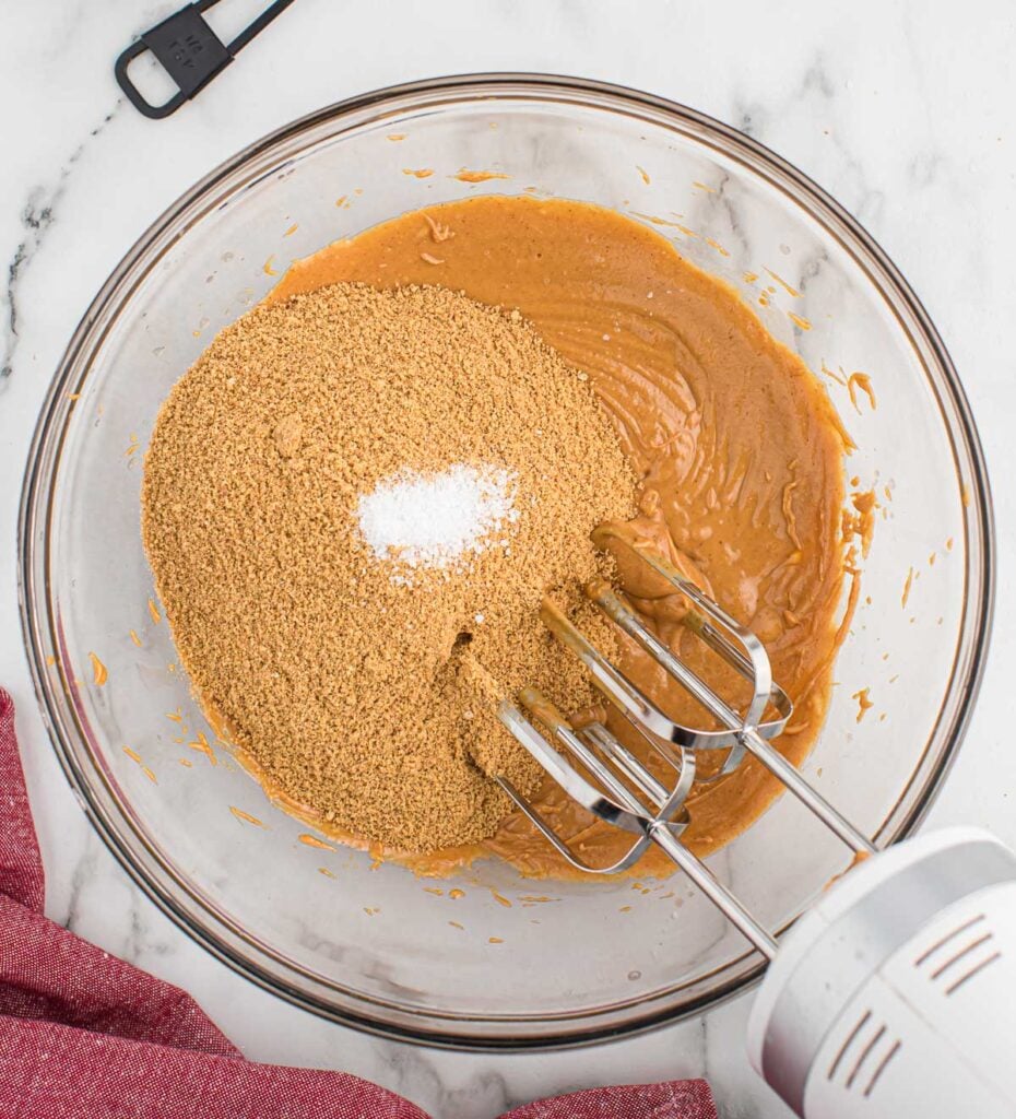 adding the graham cracker crumbs and salt to the peanut butter