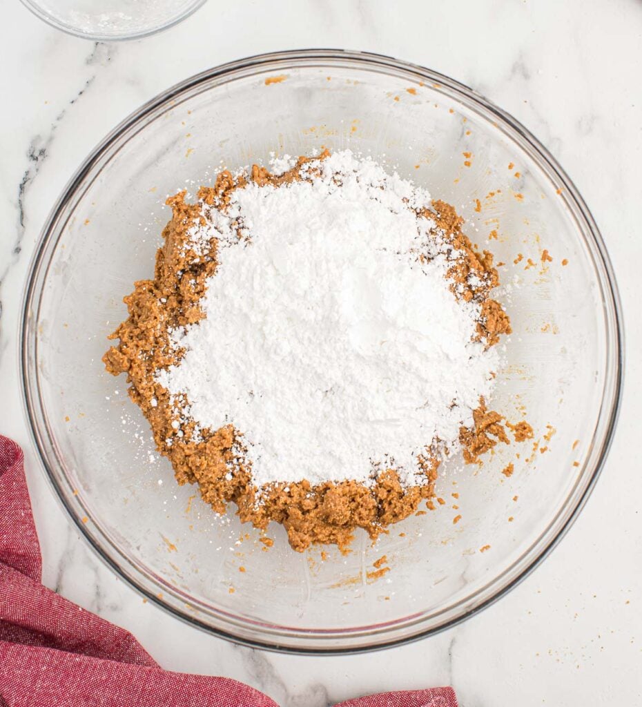 adding powdered sugar to the peanut butter balls