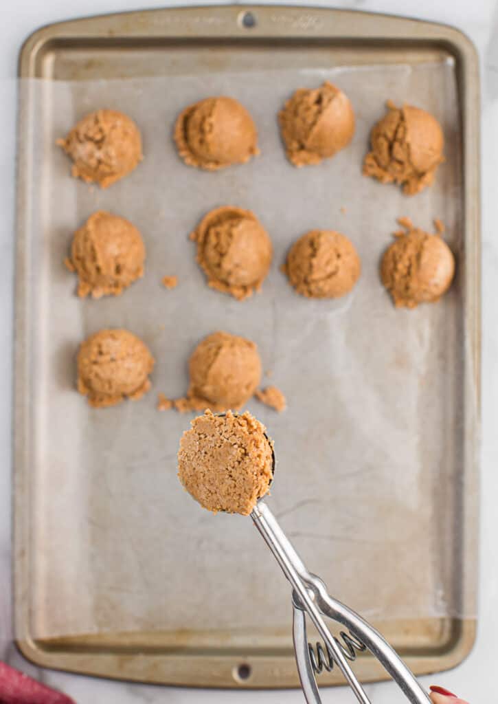 mini cookie scoop with peanut butter ball batter in it