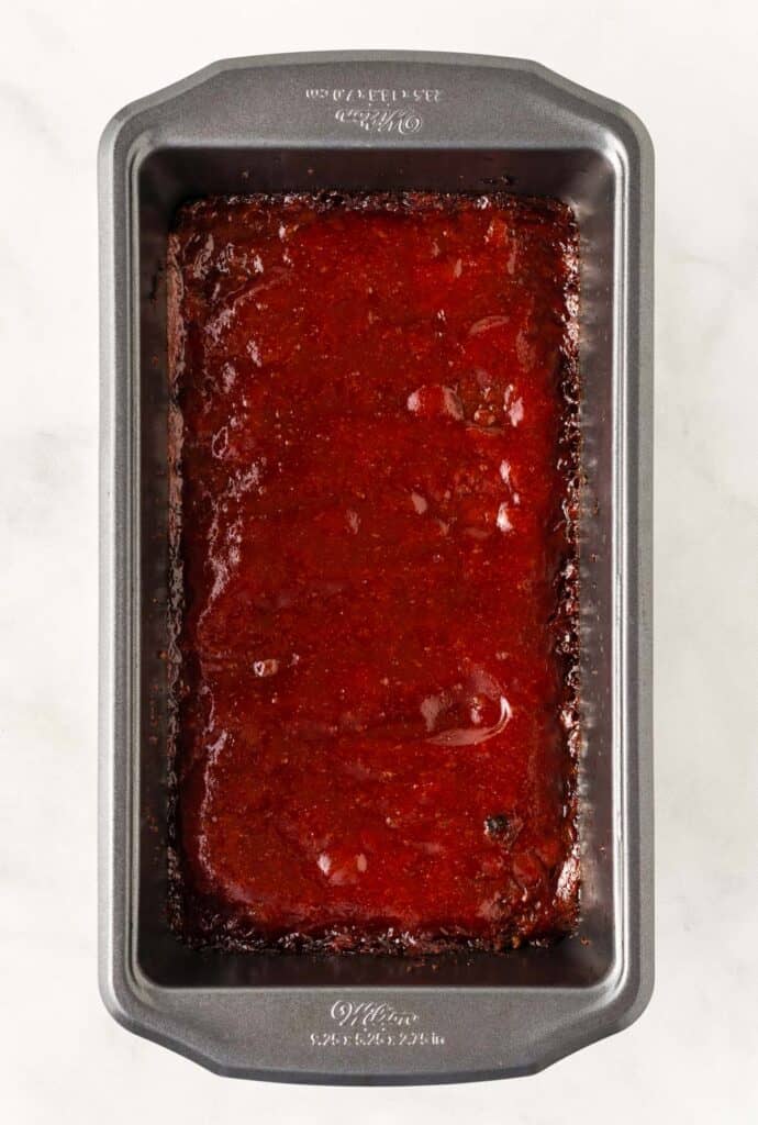 vegetarian meatloaf in a loaf pan topped with ketchup glaze