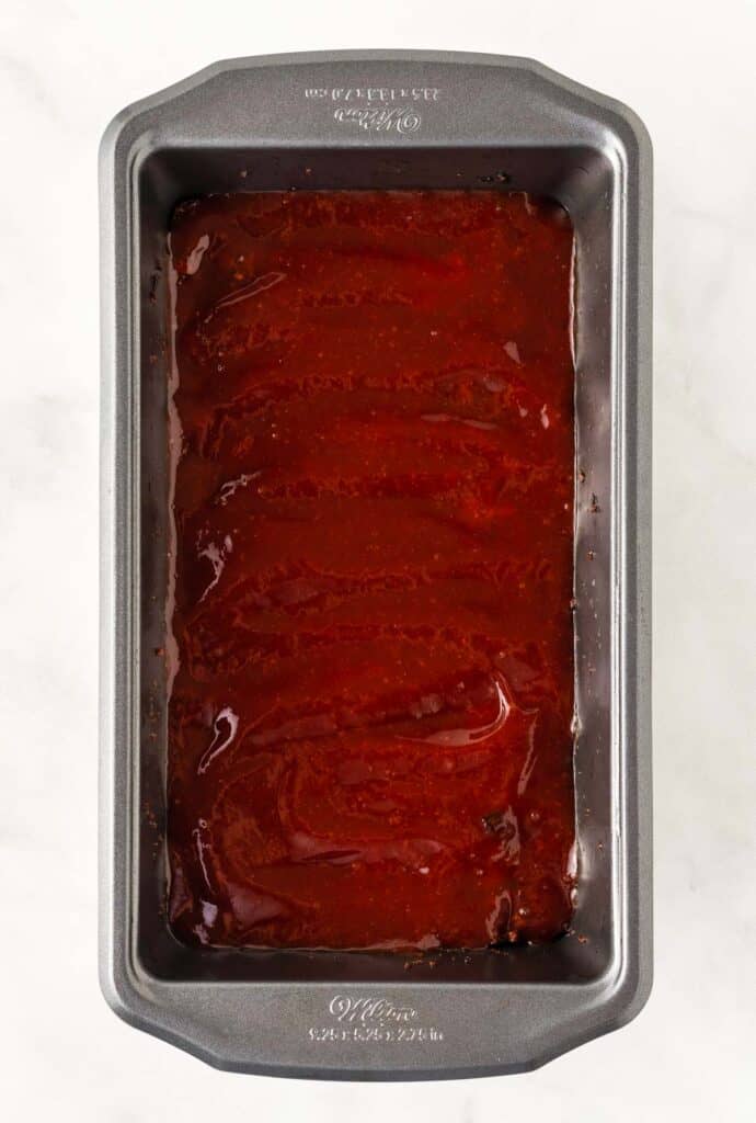 vegetarian meatloaf in a loaf pan topped with ketchup glaze
